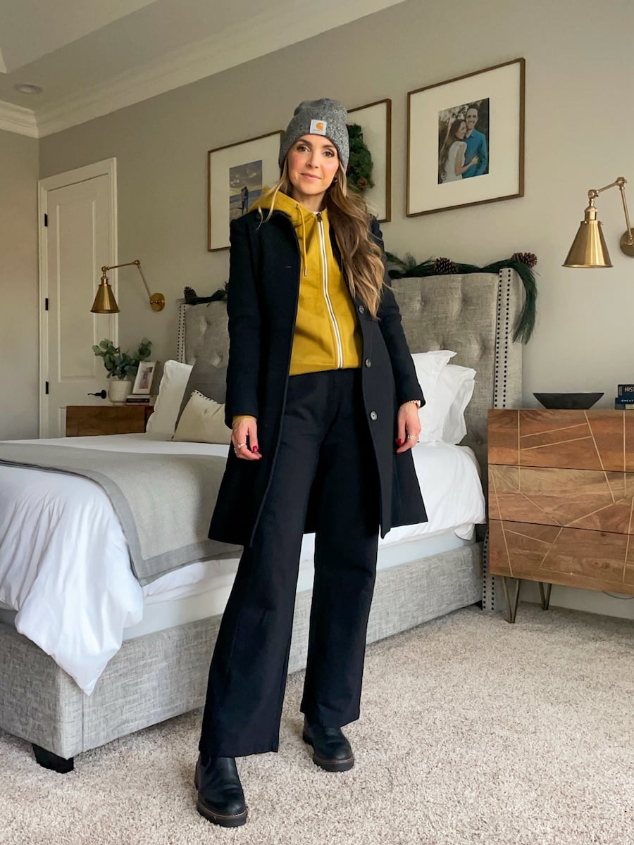 Black Long Coat Over a Pop of Yellow Zip-Up Hoodie — Colorful Winter Outfits