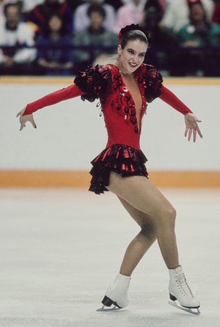 Red Dress with Ruffled Shoulders and Black Skirt for Ice Performance — Ice Skating Outfits