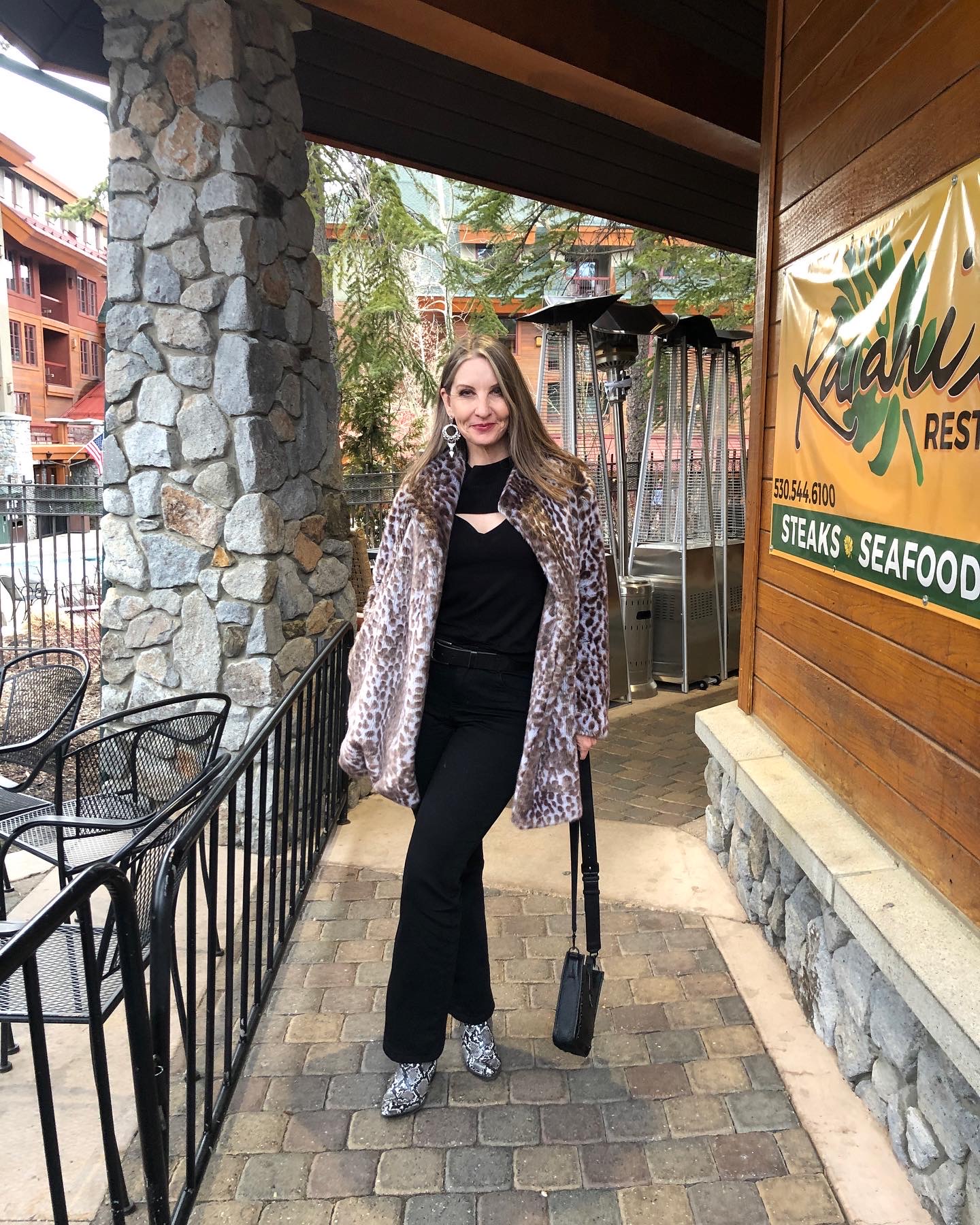 Leopard Print Faux Fur Coat Over All-Black for a Chic Winter Concert — Winter Concert Outfits