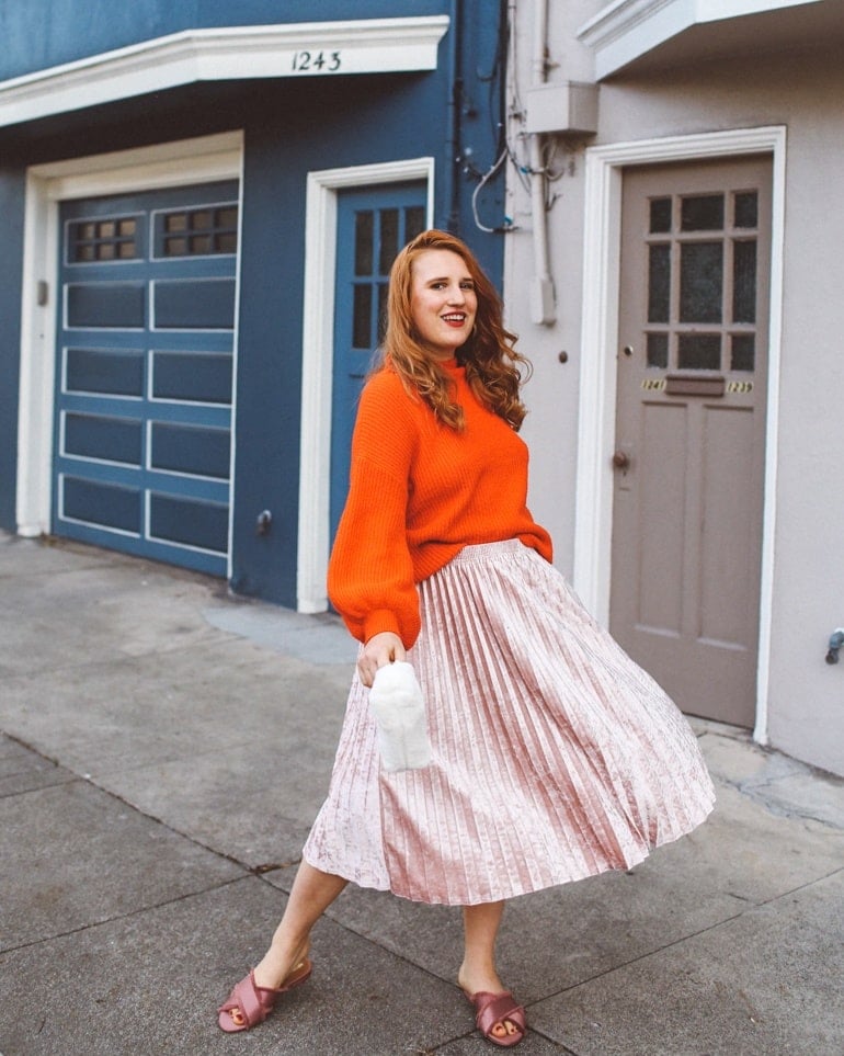 Metallic Pleated Midi Skirt with Bright Orange Knit Sweater — Winter Skirt Outfits