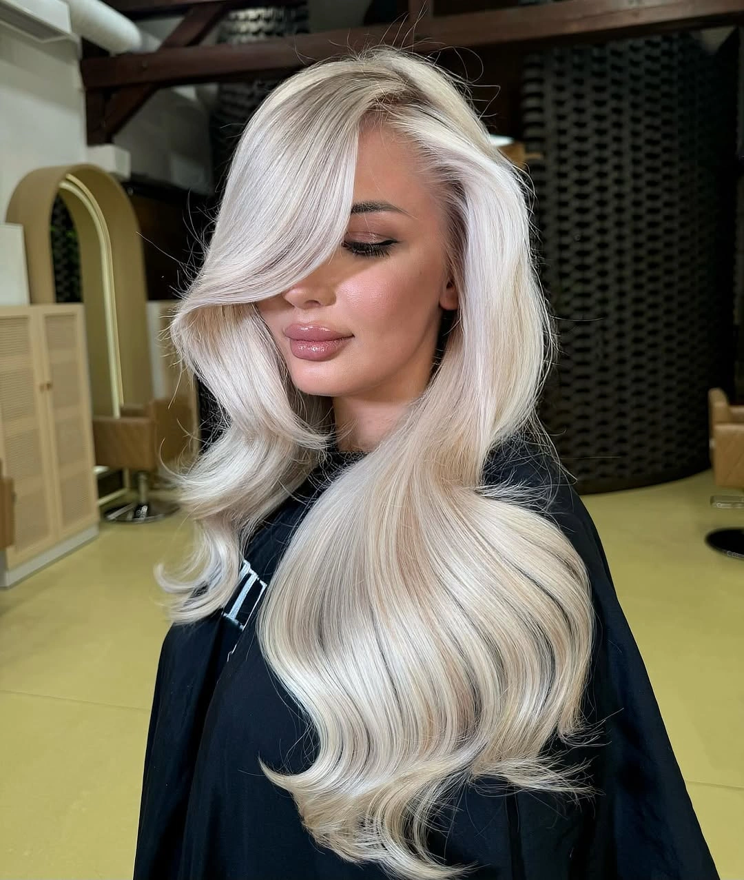 blonde winter hair color ideas - Icy Blonde Waves With a Dramatic Side Sweep