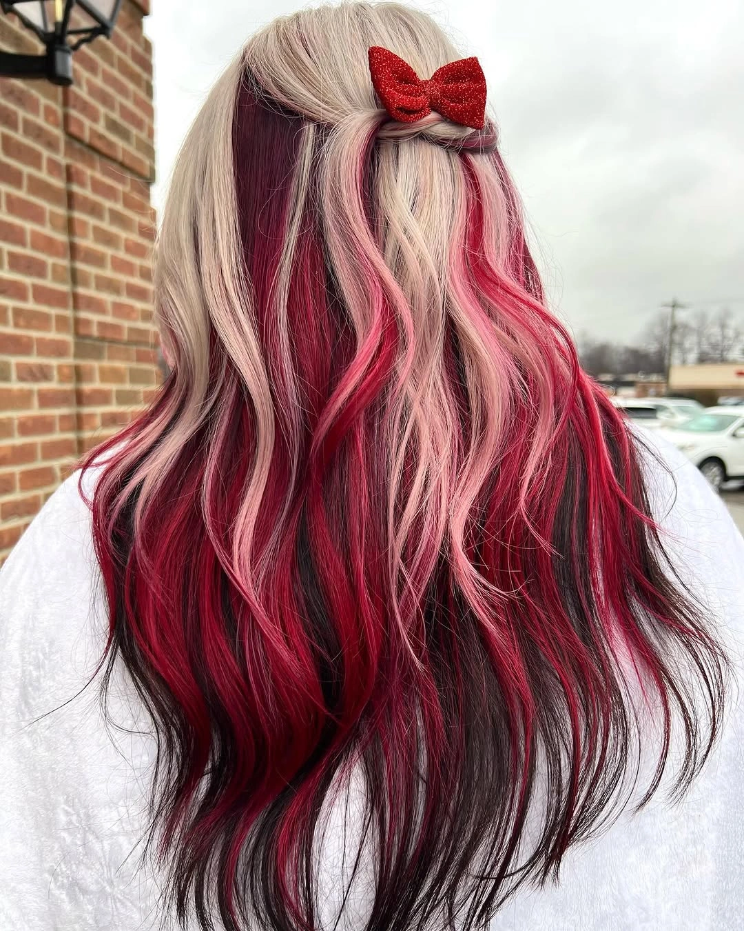 christmas hairstyles 2026 Pink And Red Waves With A Glitter Bow