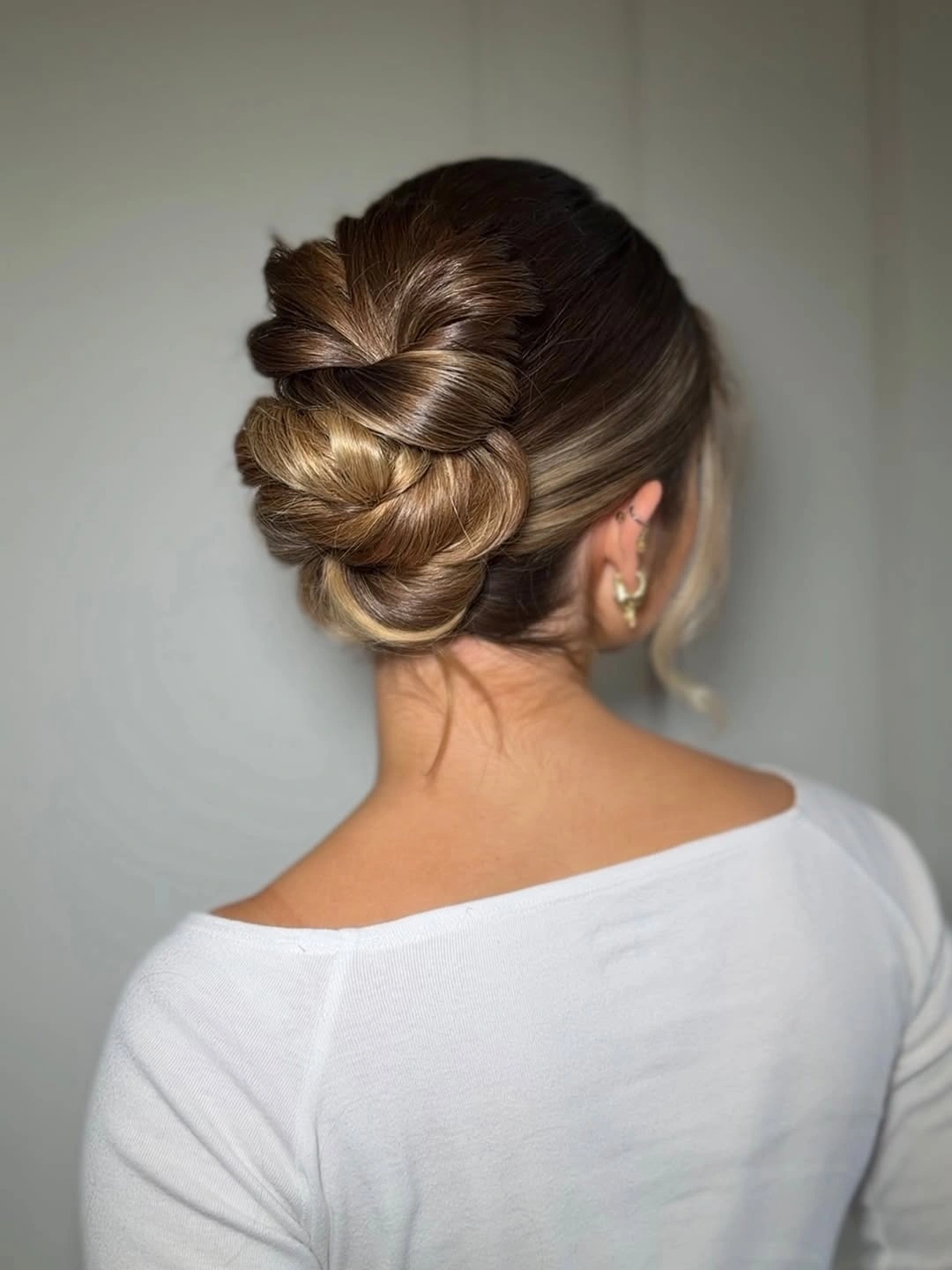 funeral hairstyles for women - Sculpted Low Updo With a Gentle Bow Detail