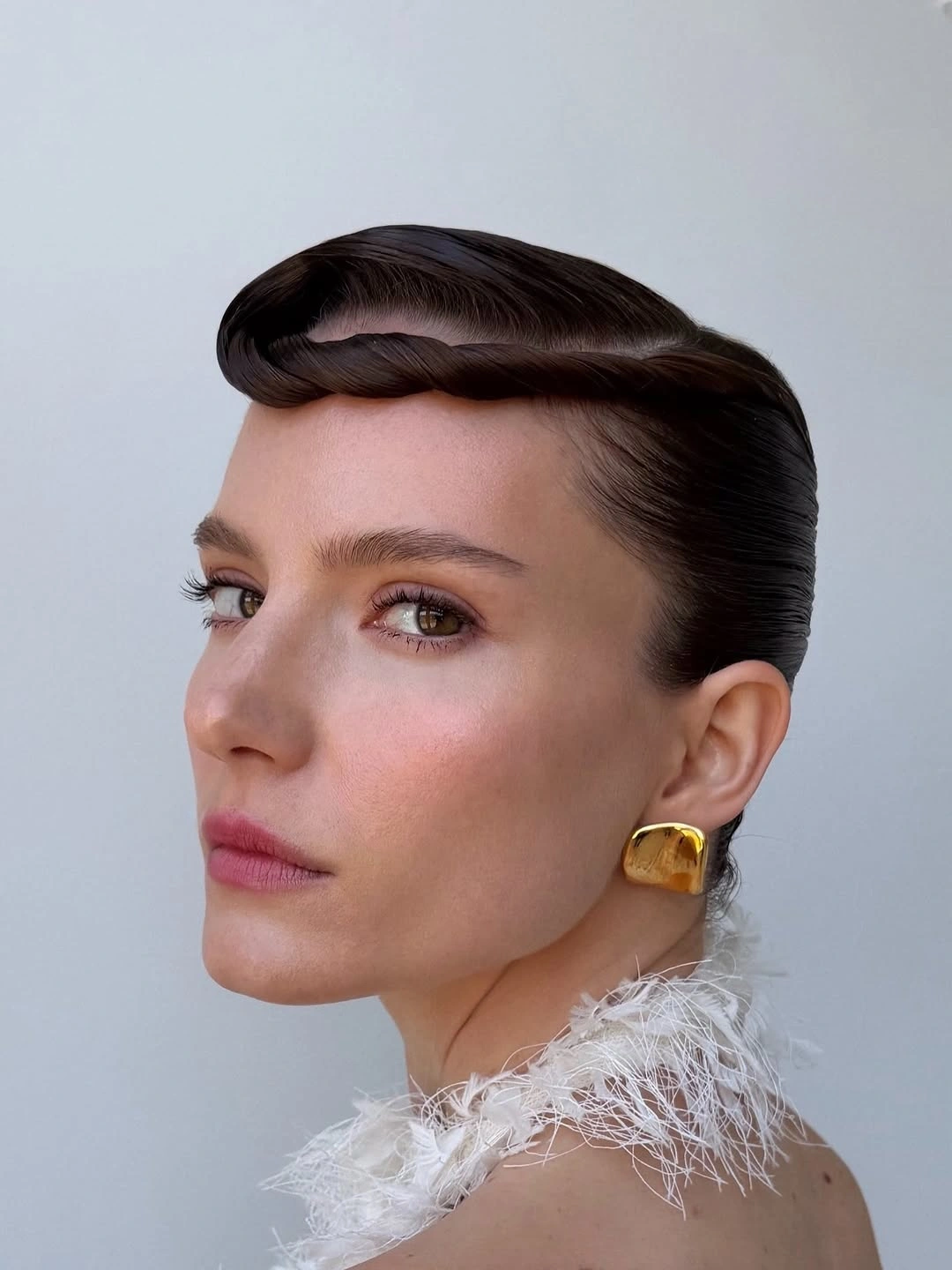 funeral hairstyles for women Glossy Sculpted Side Sweep With A Vintage Mood