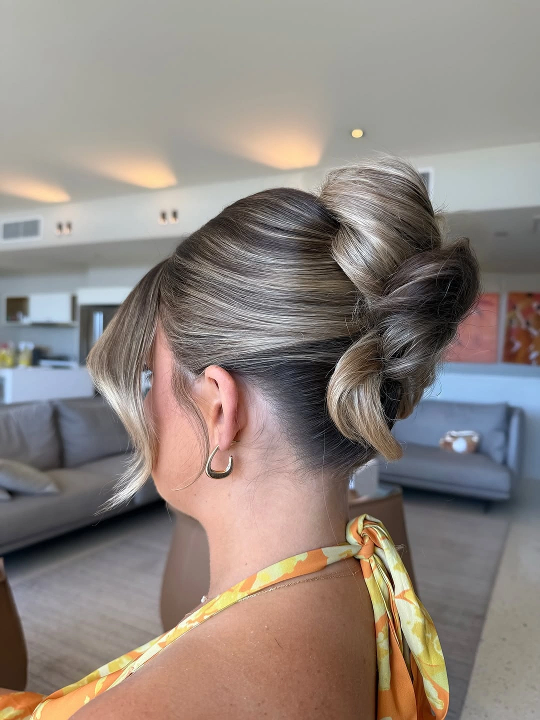 funeral hairstyles for women Soft Gray Loop Bun With Loose Face-Framing Pieces