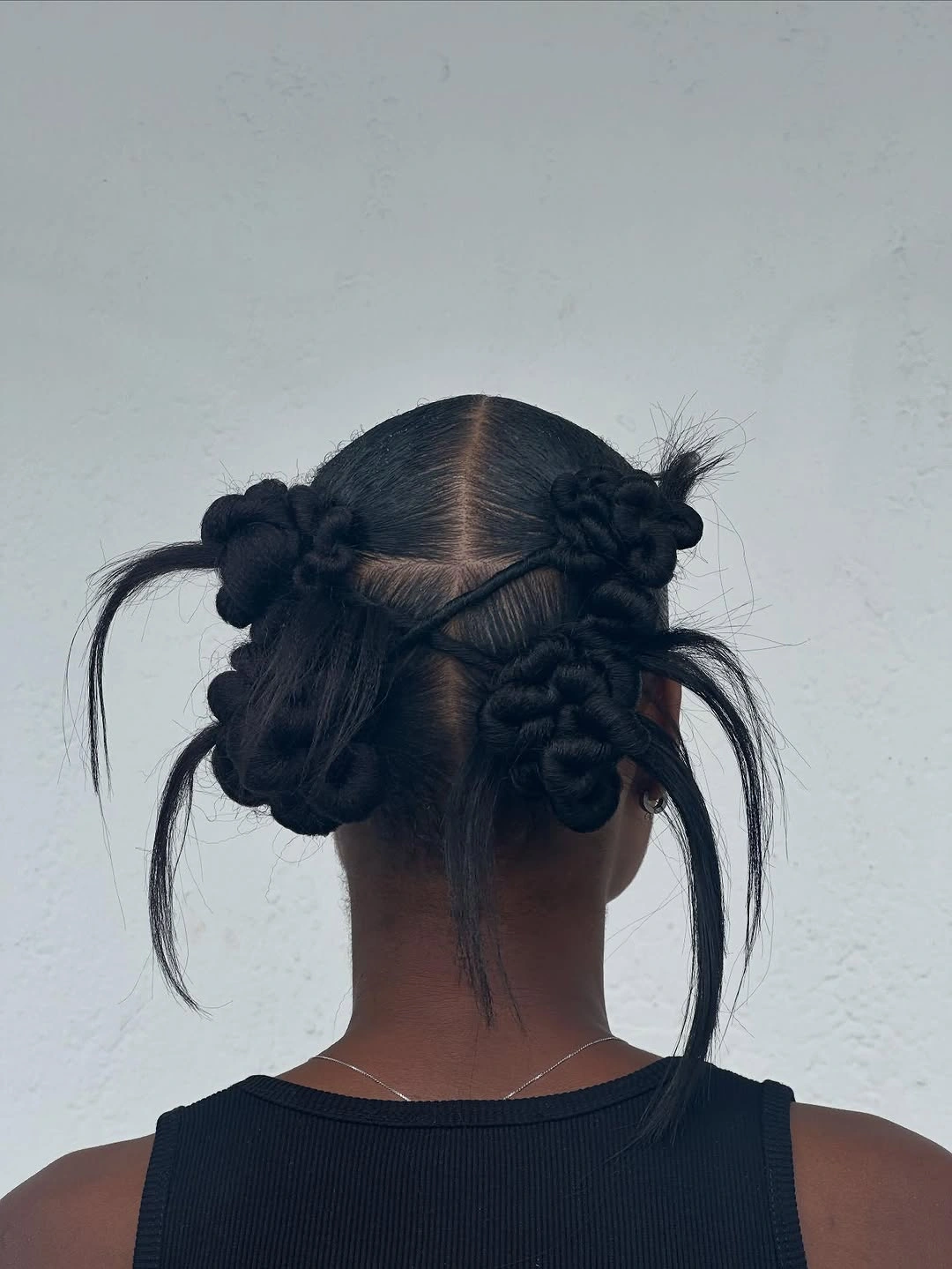 hairstyle ideas for black women 2027 Playful Multi-Bun Styling With Loose Strands