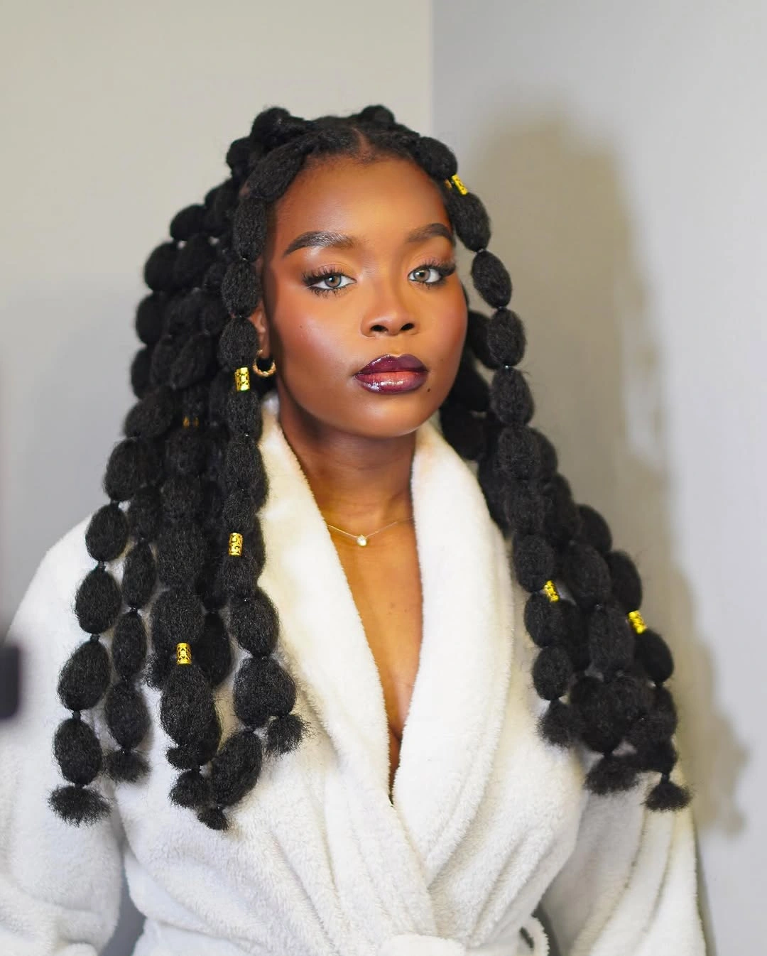 hairstyle ideas for black women 2027 Long Bubble Braids With Golden Hair Cuffs