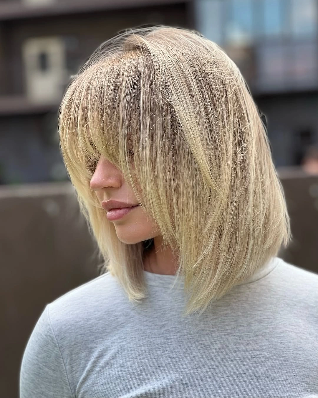 layered bob haircut Feathery Blonde Bob With Full Bangs