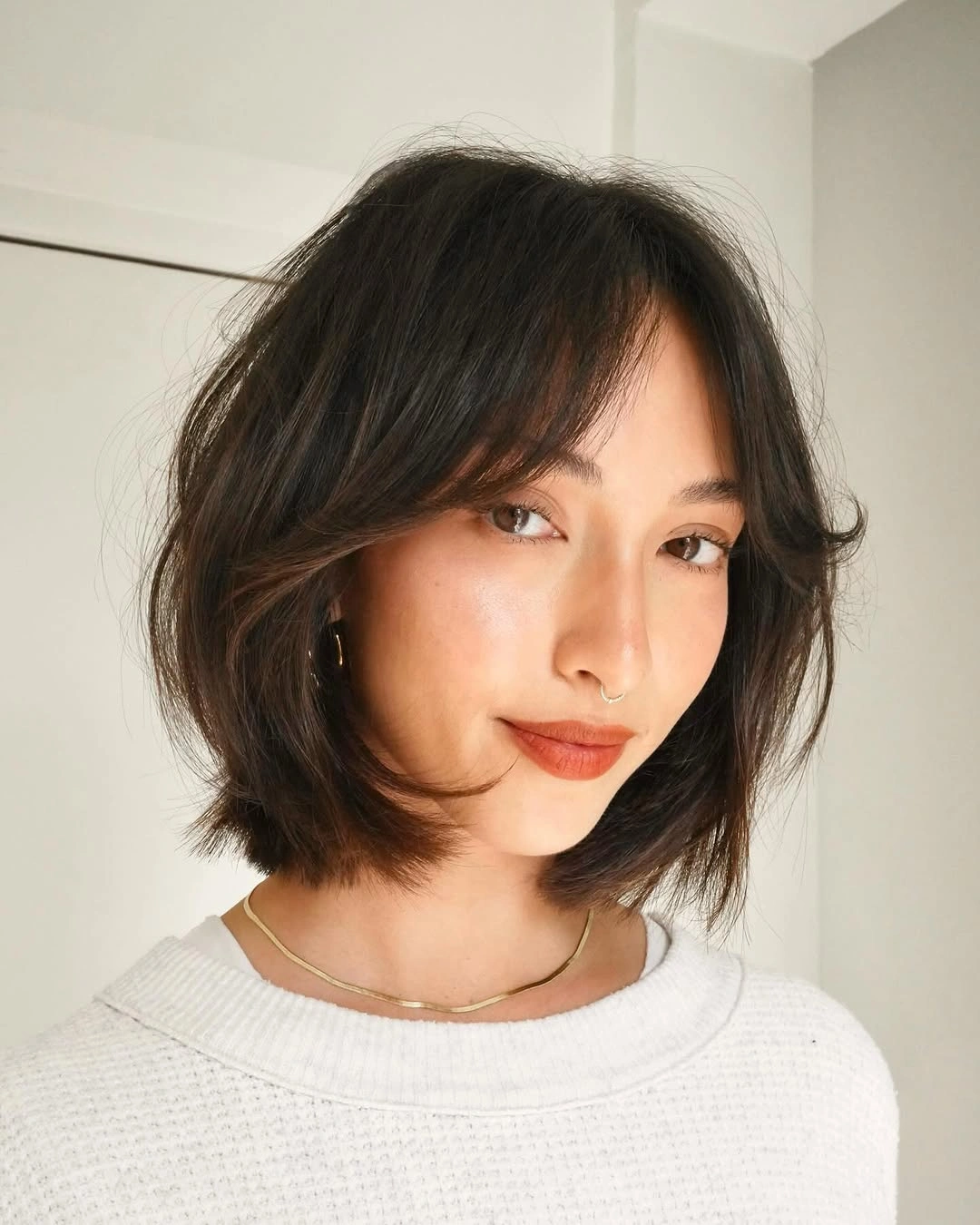 layered bob haircut Dark Bob With Wispy Curtain Bangs
