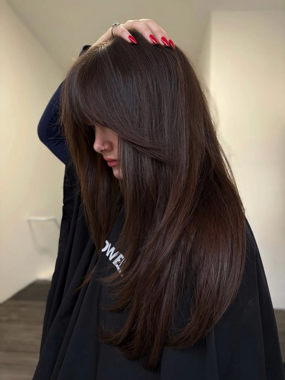 november haircut ideas 2026 Deep Brunette Layers With A Draped Fringe