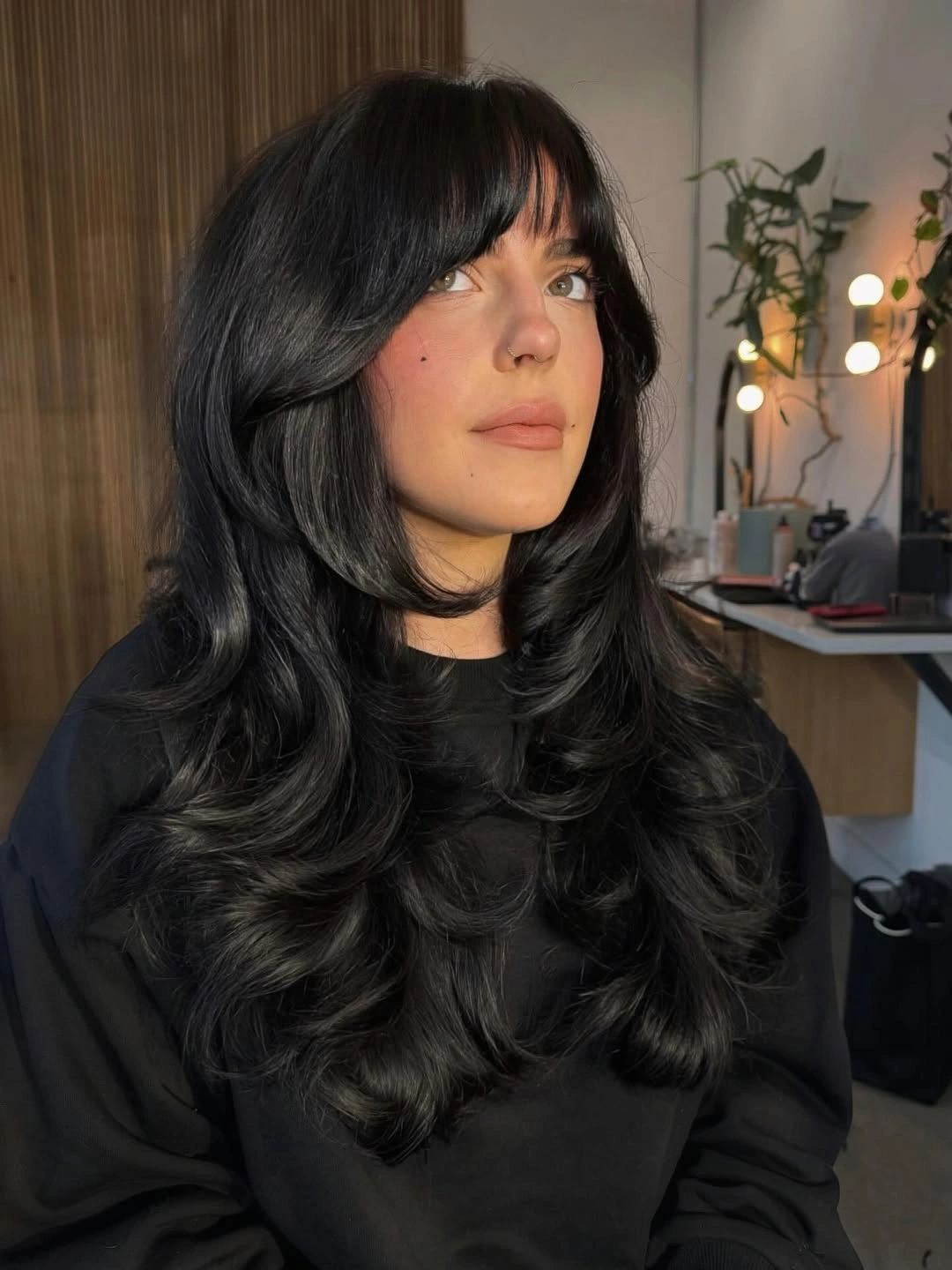 november haircut ideas 2026 Glossy Black Layers With Soft Curtain Bangs