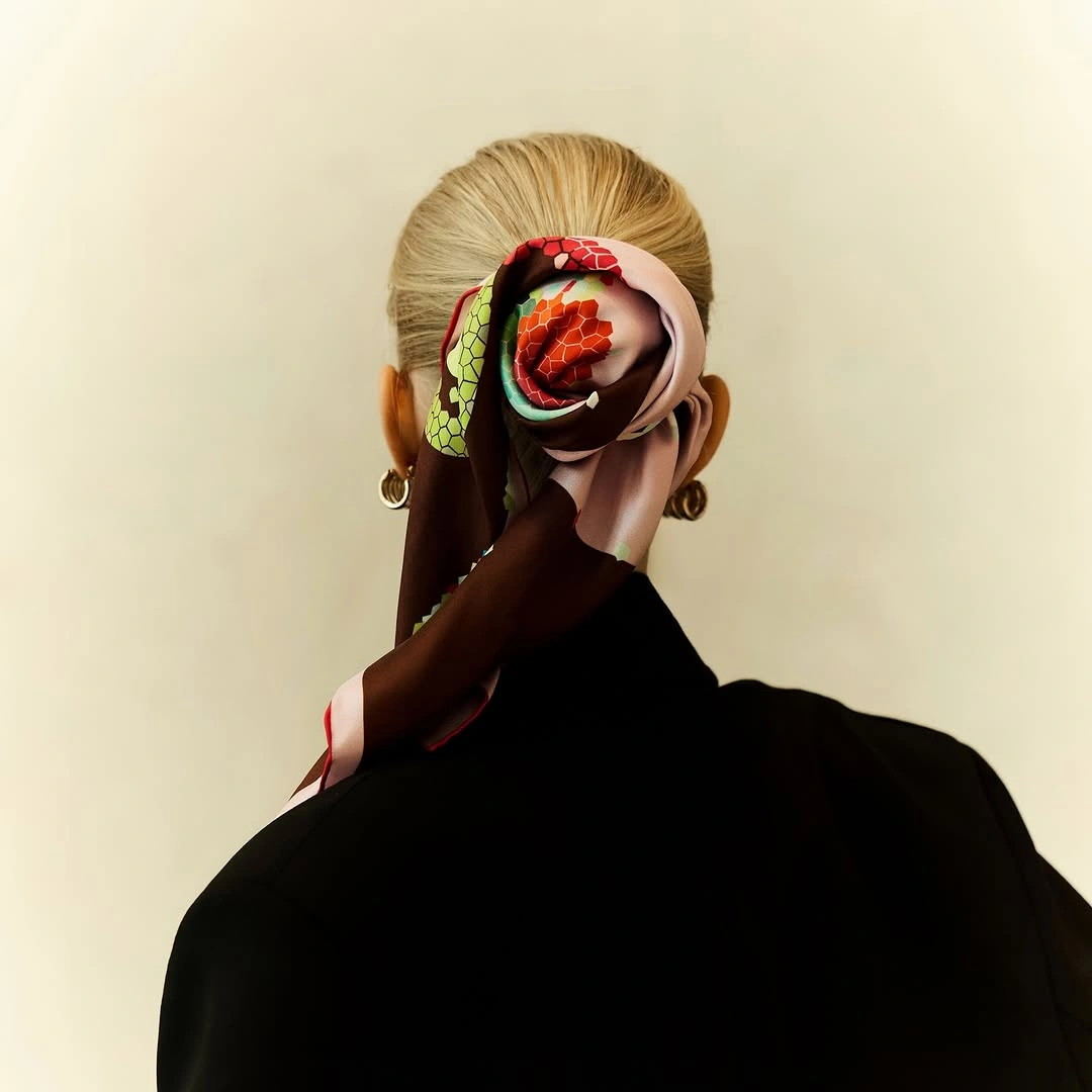 scarf hairstyle for women Statement Scarf Wrapped Around a Sleek Bun
