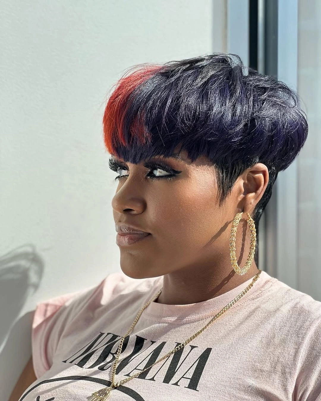 trendy haircuts for black women 2027 Graphic Pixie With A Copper Accent