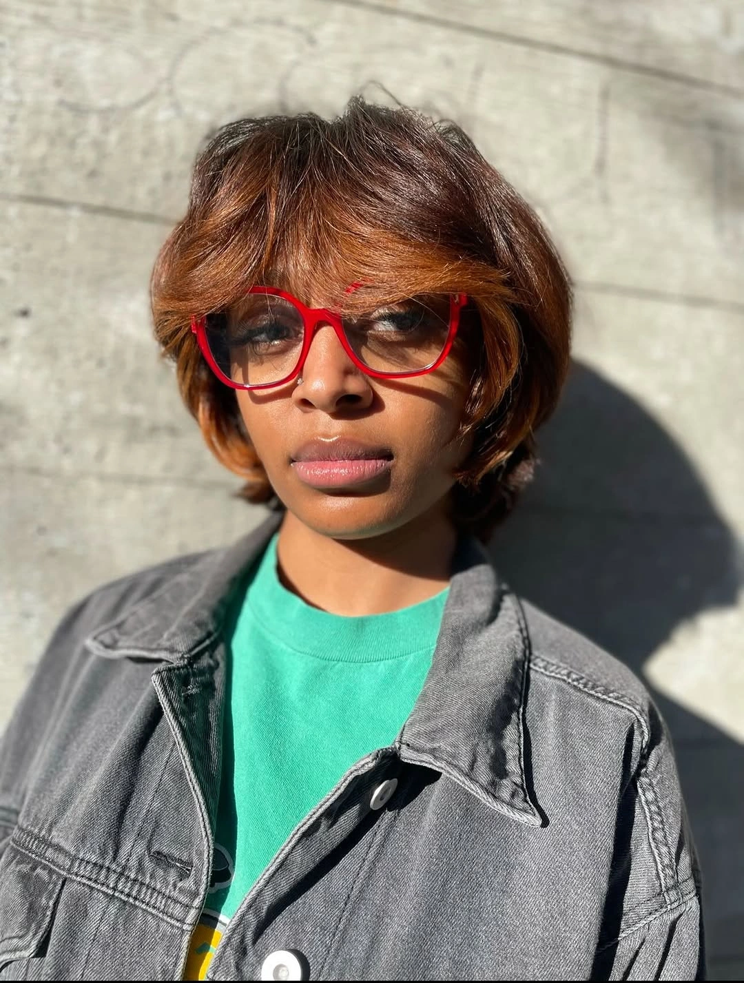 trendy haircuts for black women 2027 Warm Layered Bob With Side Swept Bangs