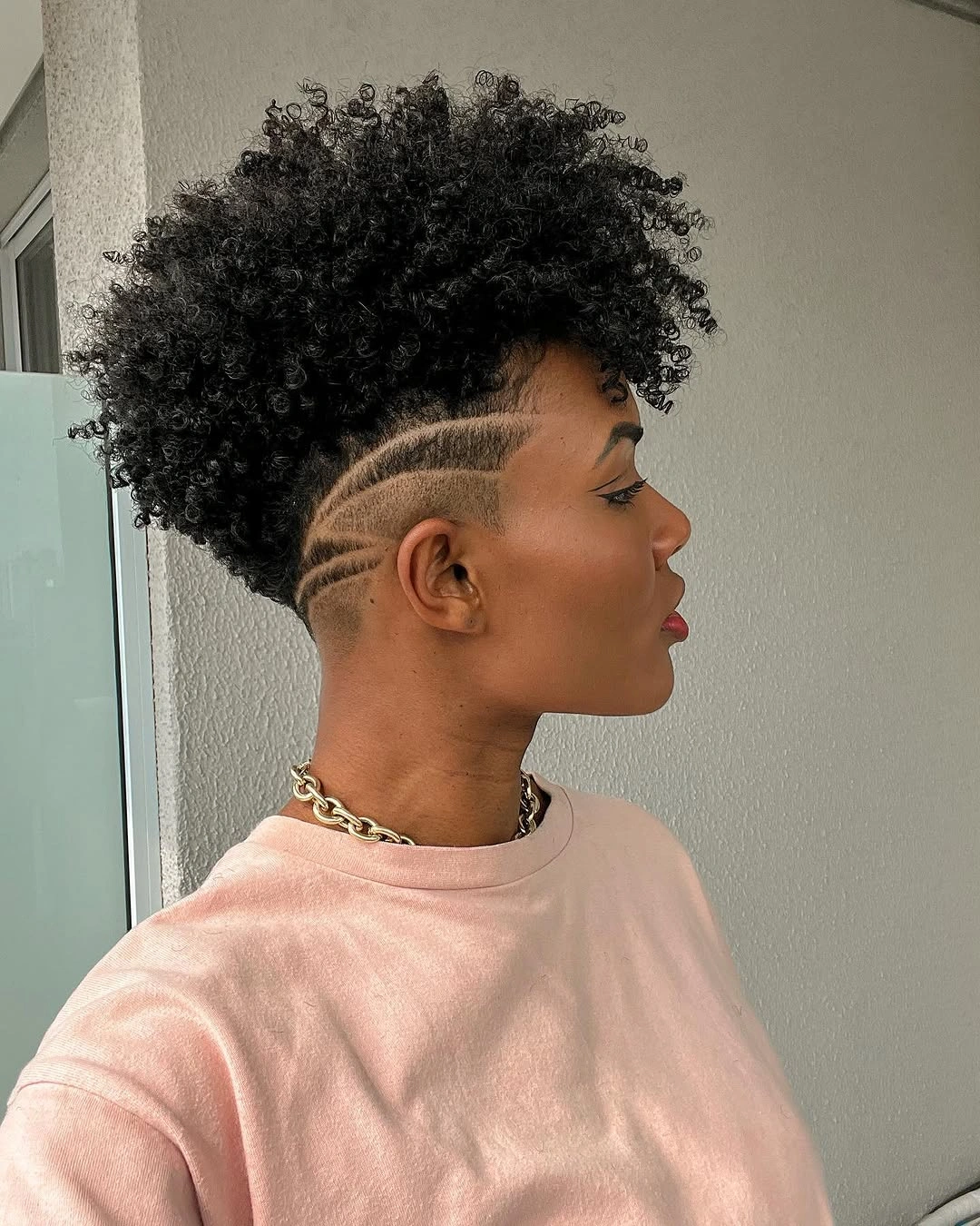 trendy haircuts for black women 2027 Curly Tapered Crop With A Graphic Undercut