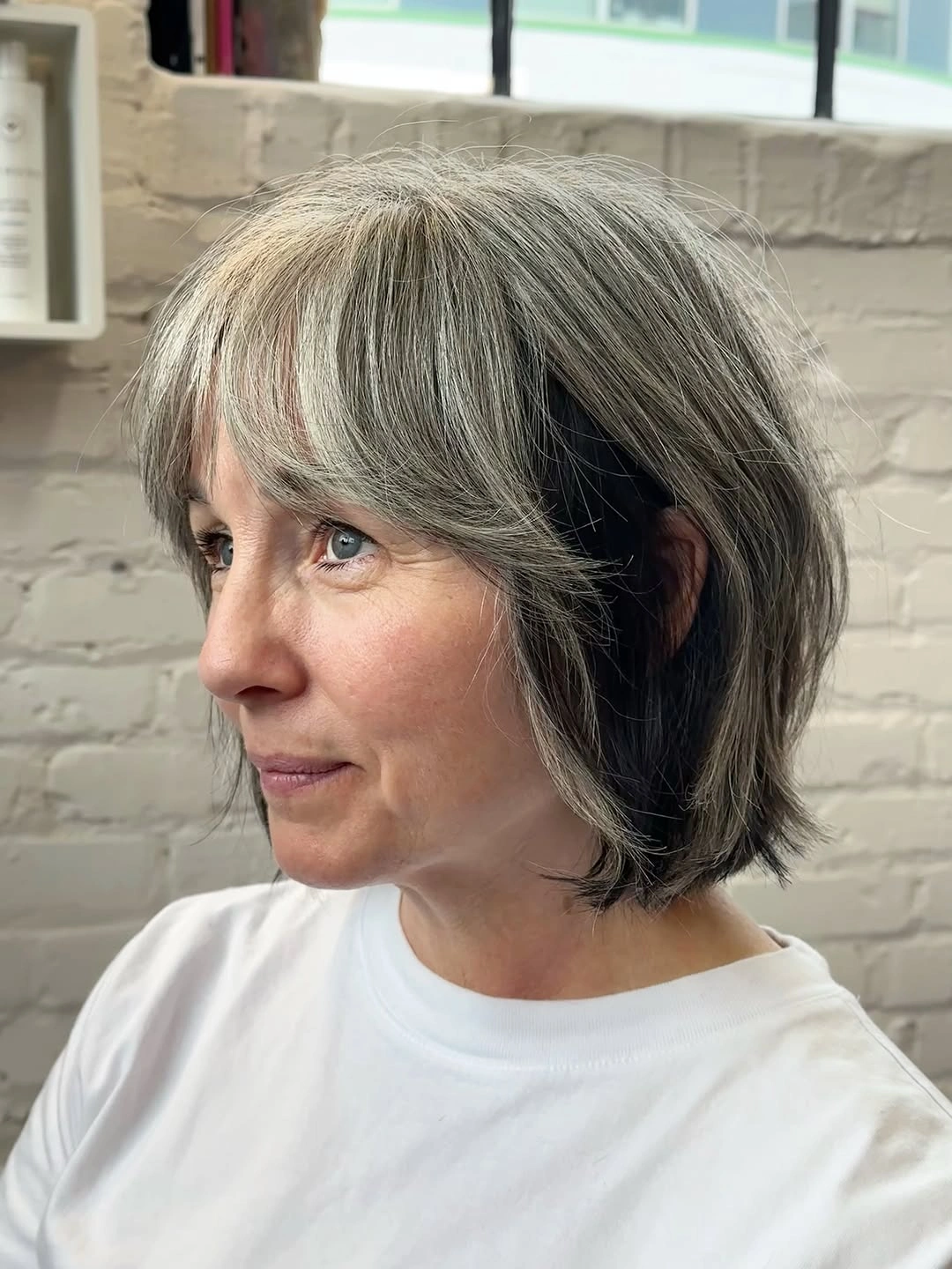 trendy haircuts for women over 40 2027 Layered Silver Bob with Curtain Bangs