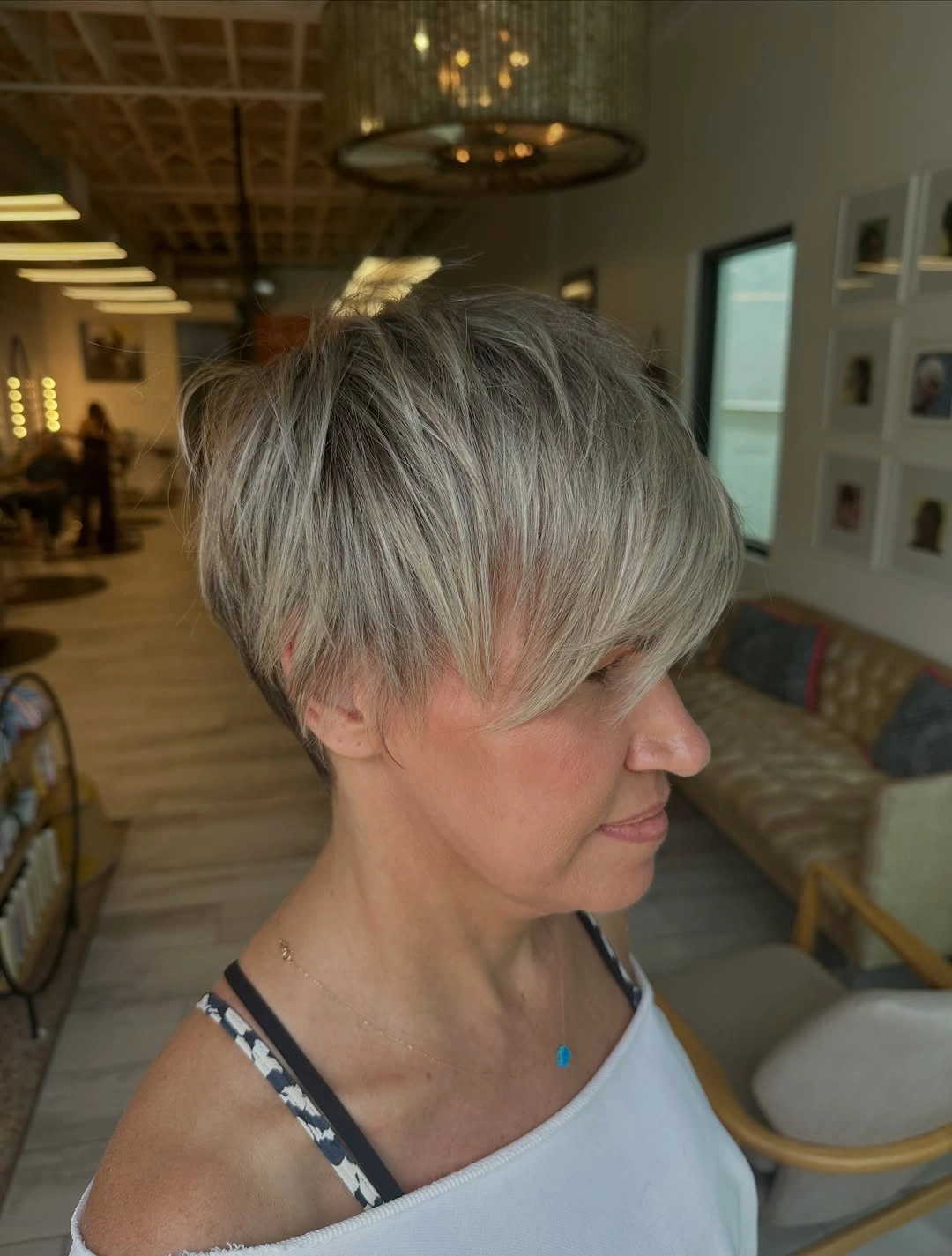 trendy haircuts for women over 50 2027 Soft Layered Pixie with Long Bangs