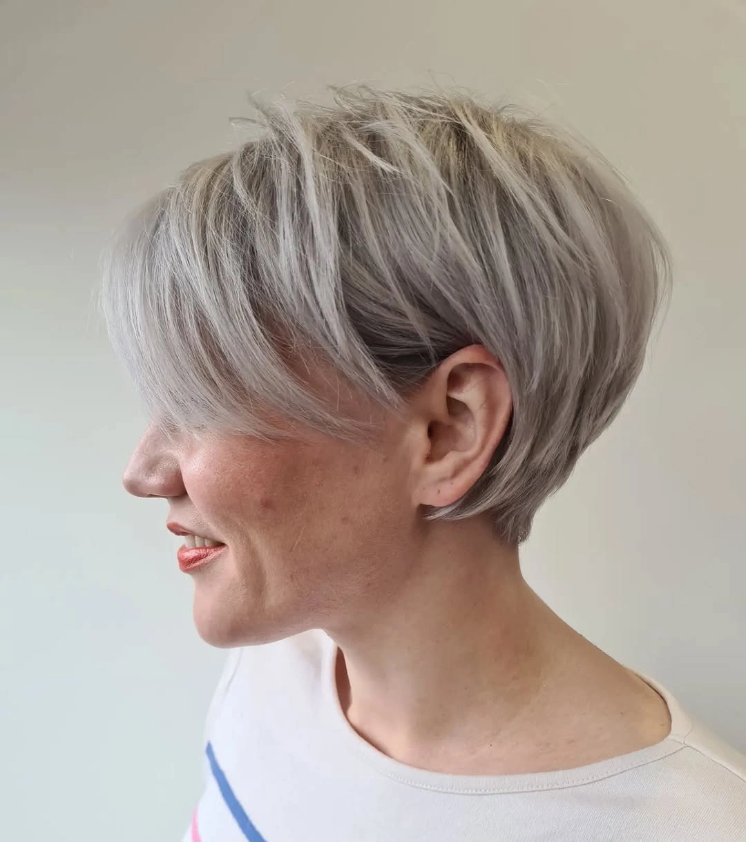 trendy haircuts for women over 50 2027 Textured Silver Pixie with Sweeping Bangs