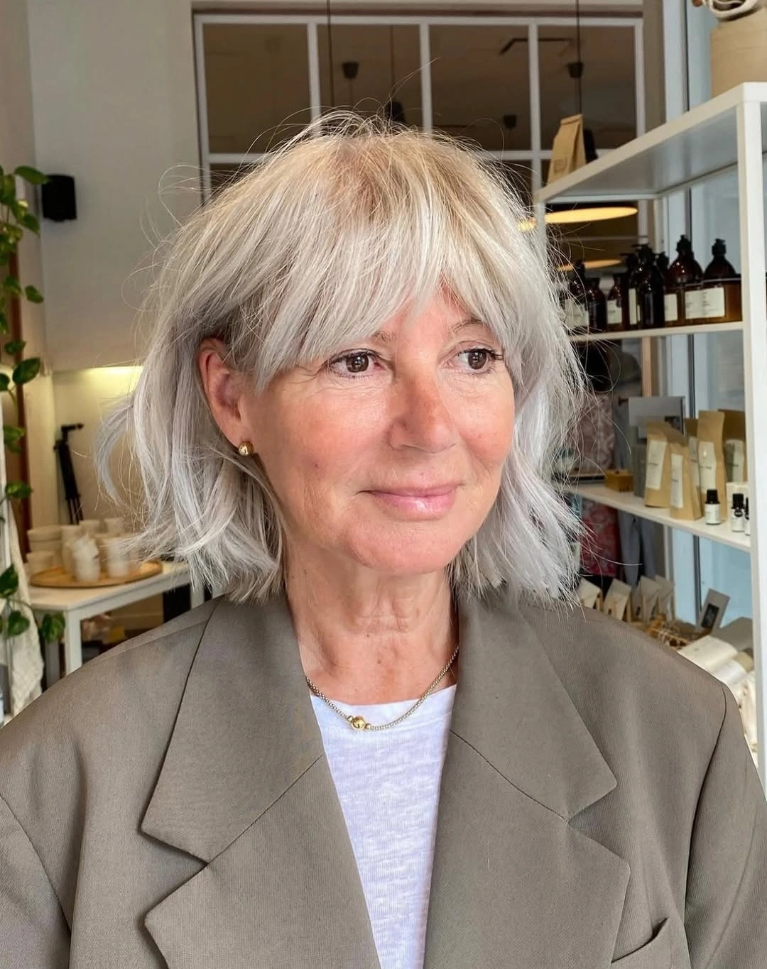 trendy haircuts for women over 50 2027 Feathered Silver Shag Bob