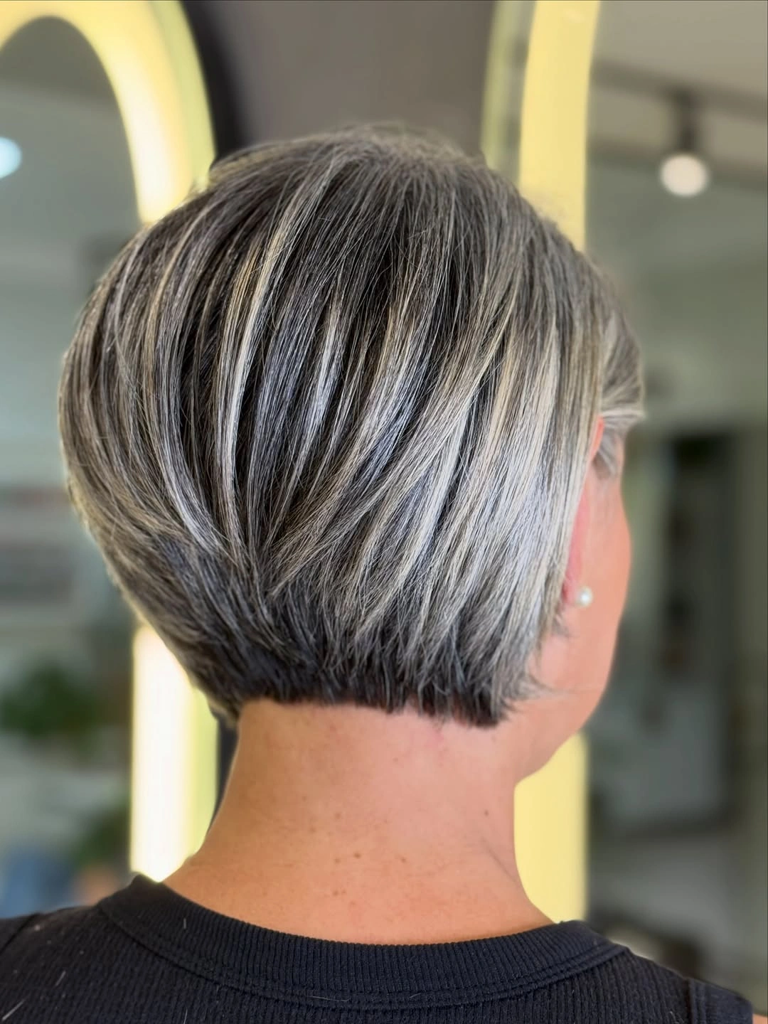 trendy haircuts for women over 50 2027 Sleek Graduated Salt and Pepper Bob