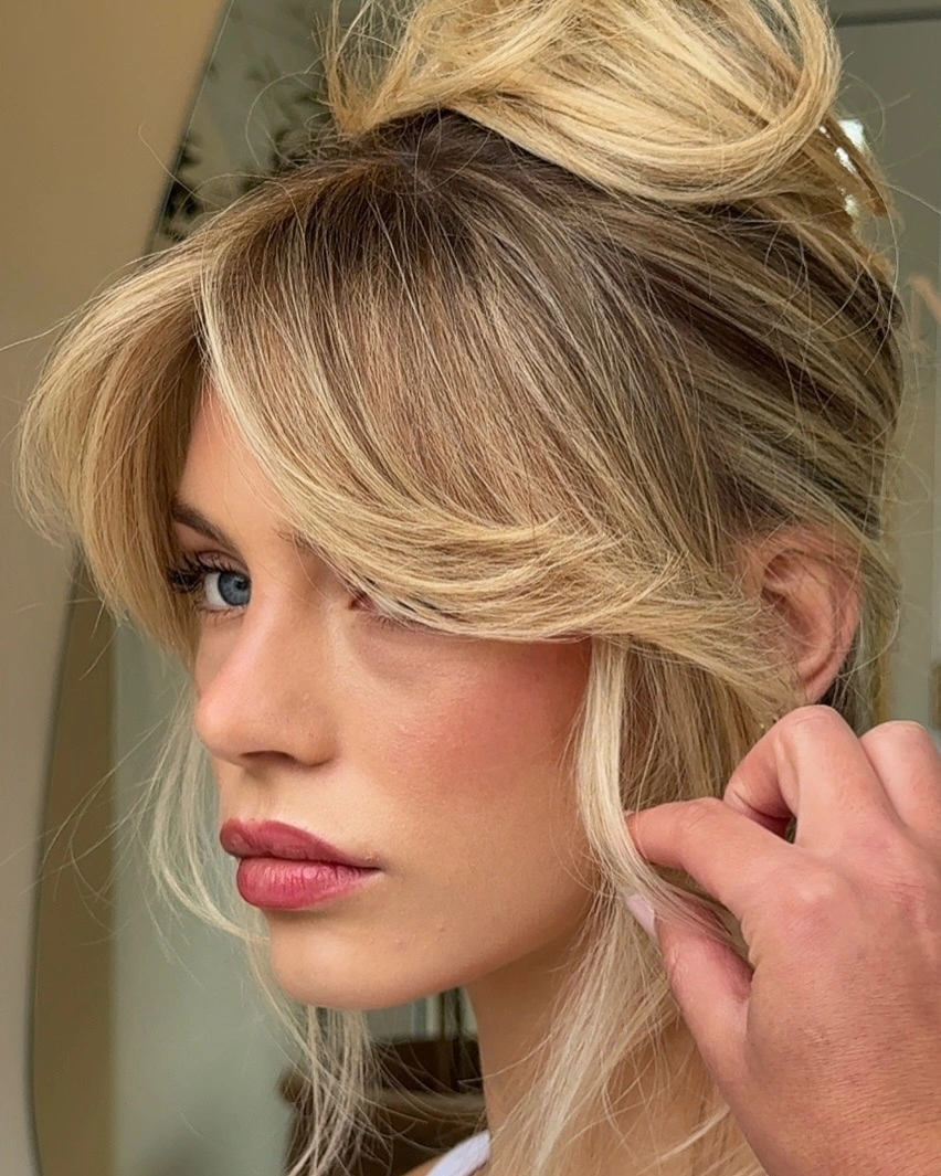 up hairstyles for women Blonde Top Knot with Curtain Bangs