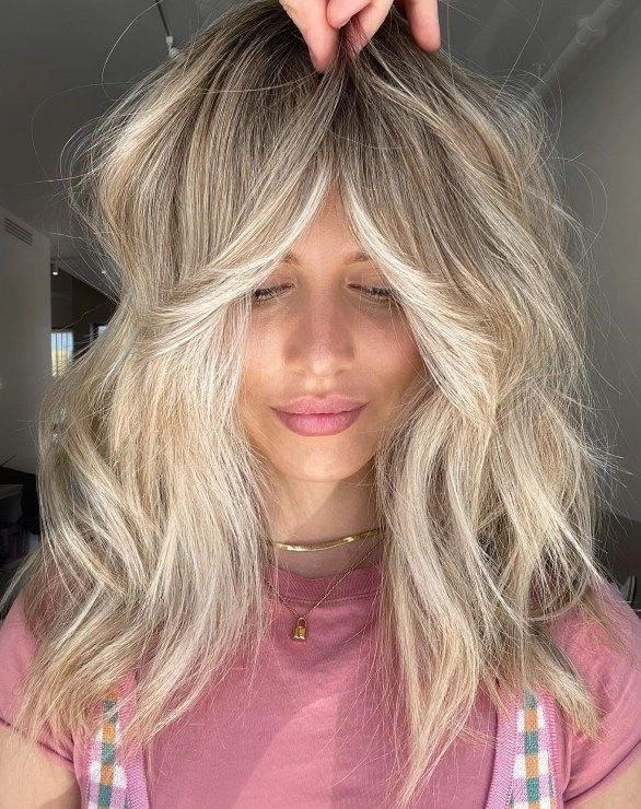 winter haircuts Champagne Blonde With Soft Curtain Layers