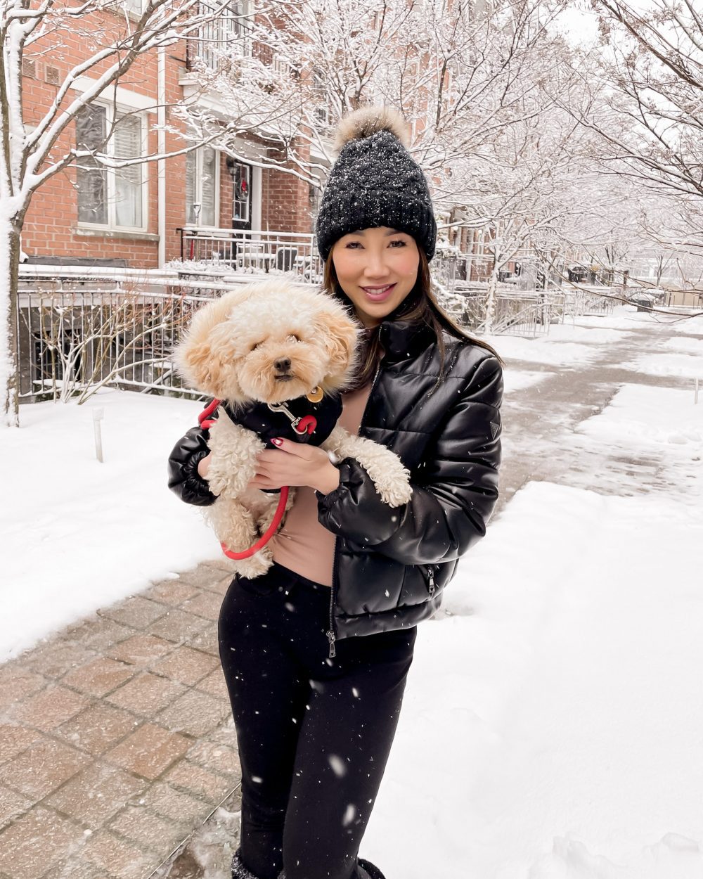 Black Puffer Jacket with Pink Top and White Sneakers in the Snow Black Puffer Jacket with Pink Top and White Sneakers in the Snow — Snow Day Outfits