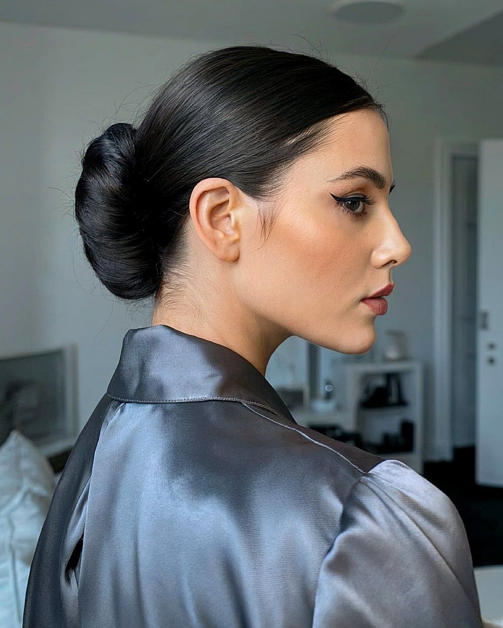 Black Sleek Sculpted Low Bun — Winter Date Night Hairstyles