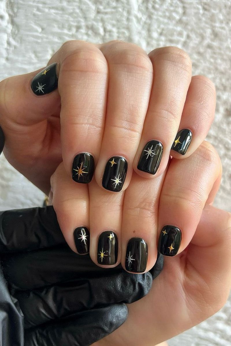 Glossy Black with Festive Star Accents Glossy Black with Festive Star Accents — Winter Black Nails