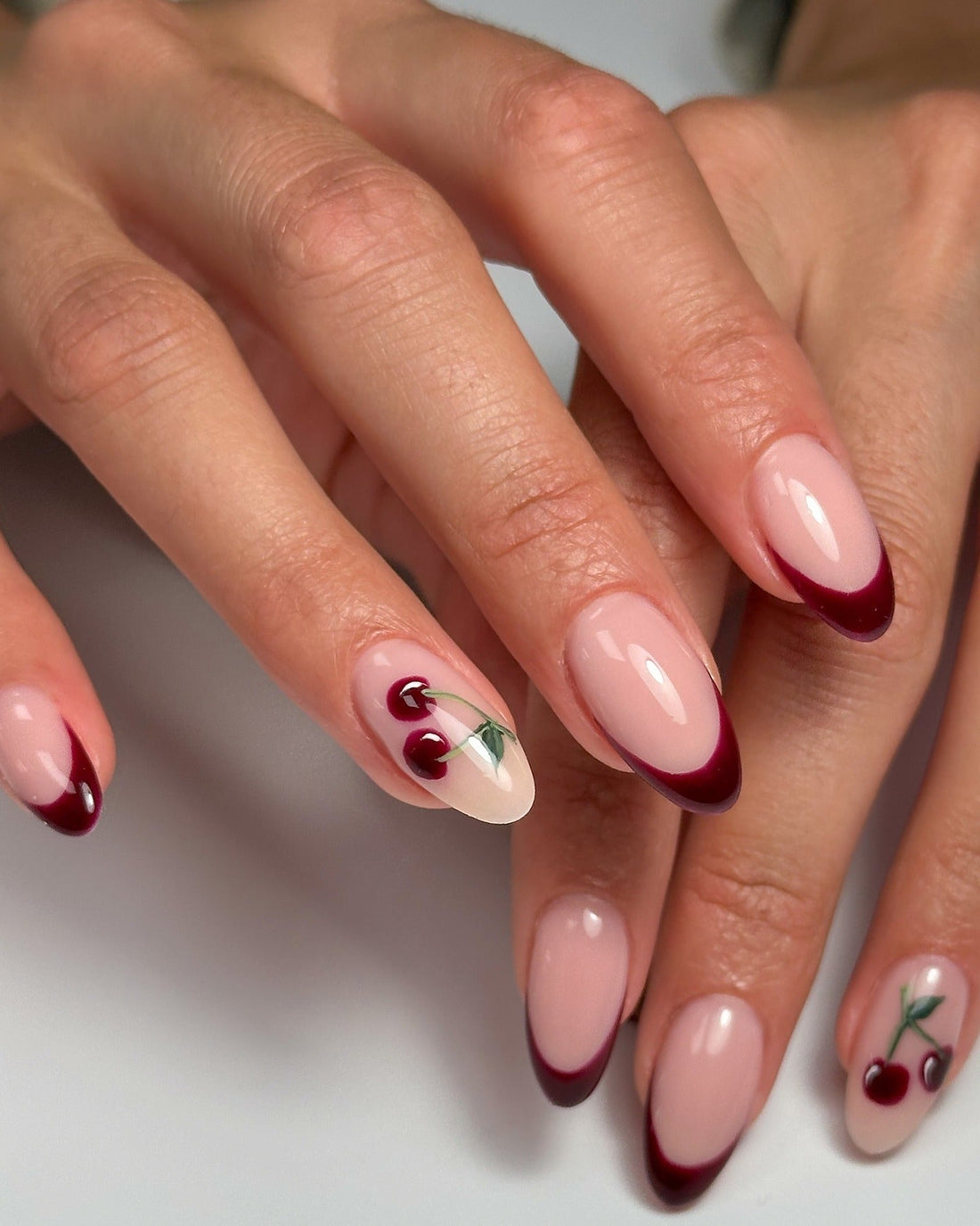 Oval French Tips with Delicate Cherry Motifs Oval French Tips with Delicate Cherry Motifs — Cherry Red Nails