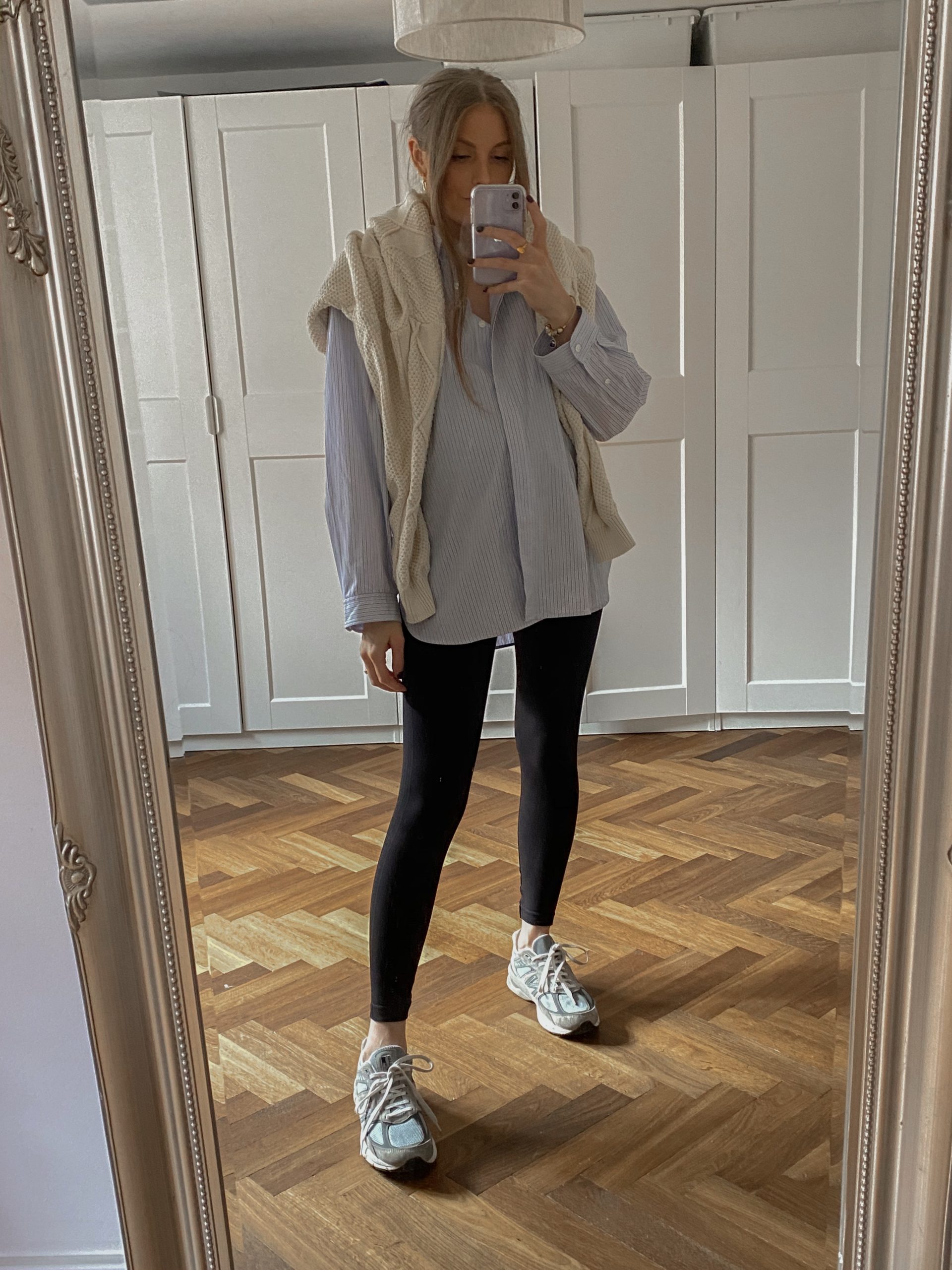 Cable-Knit Sweater Draped Over a Striped Shirt with Sneakers — Winter Outfits with Leggings