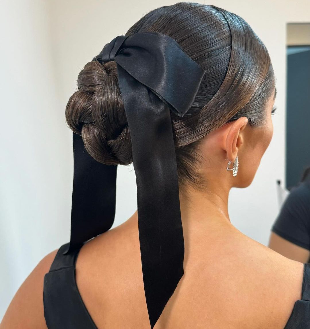 Dark Brown Braided Bun with Dramatic Satin Bow — Winter Party Hairstyles