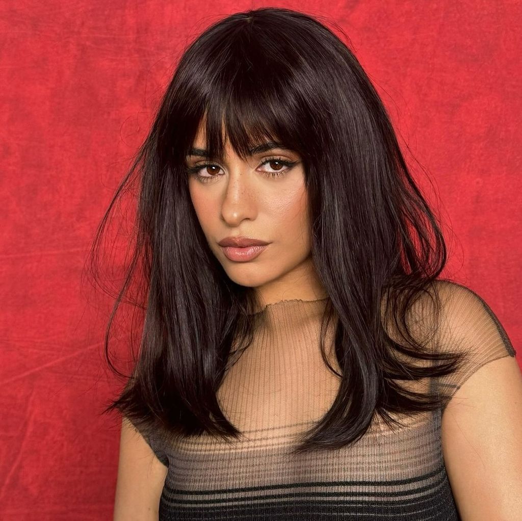 Mid-Back Loose Waves With Full Bangs — Winter Haircuts for Long Faces