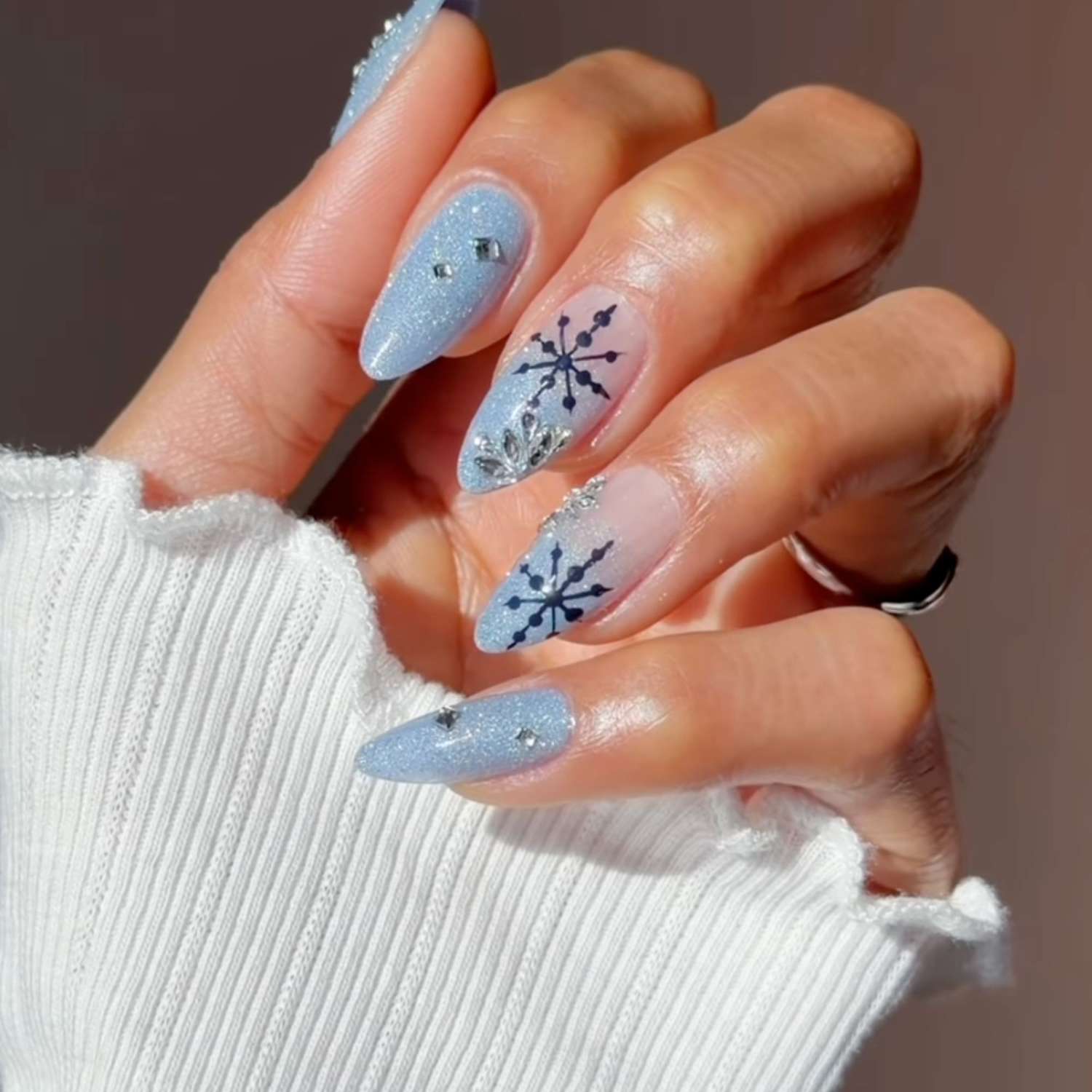 Winter Holiday Icy Blue Stilettos with Matte Snowflakes Winter Holiday Icy Blue Stilettos with Matte Snowflakes — Pastel Winter Nails