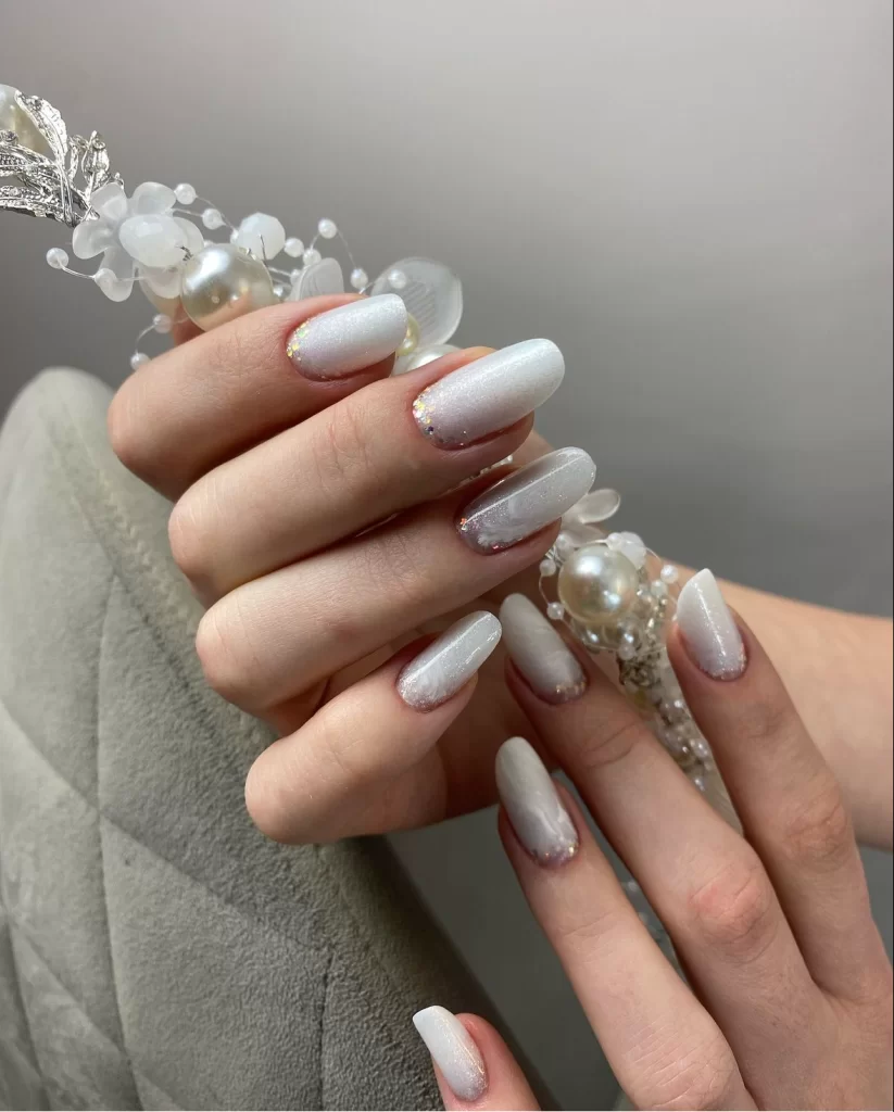 Cool White Pearlescent Shimmer Almond Nails Cool White Pearlescent Shimmer Almond Nails — Medium Length Winter Nails