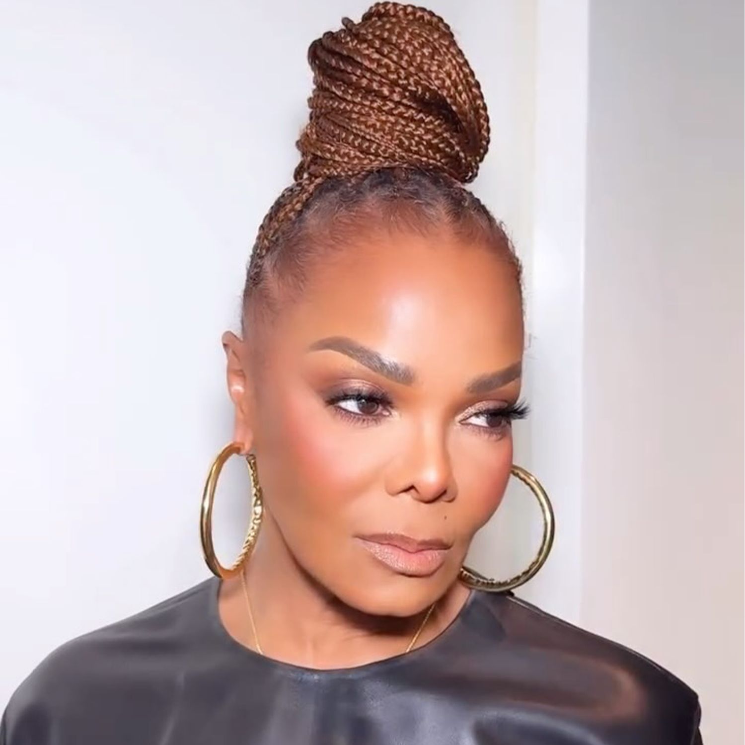 High Tightly Braided Dark Brown Bun — Winter Bun Hairstyles