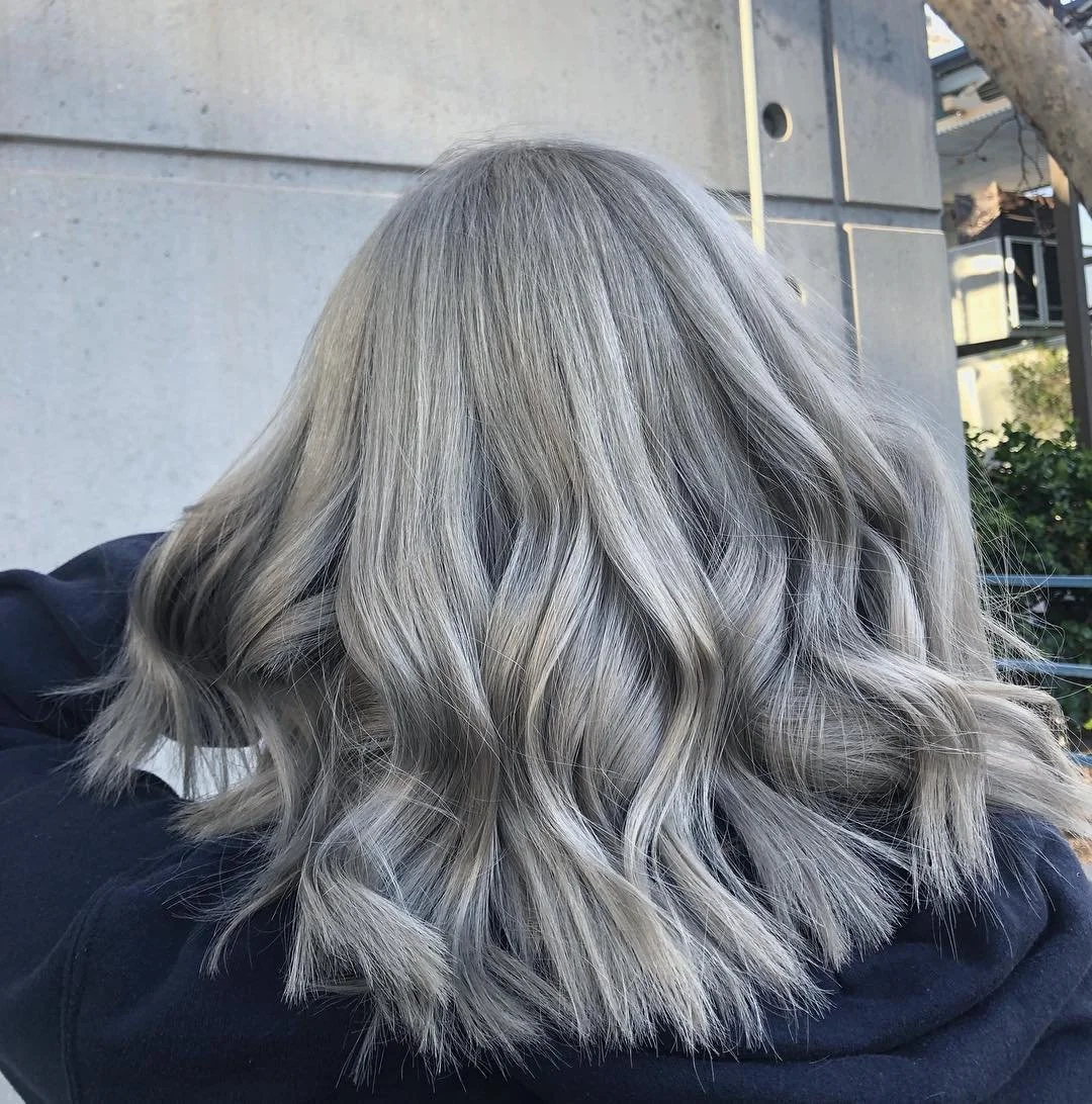 Ash Grey Layered Waves With Dark Roots Ash Grey Layered Waves With Dark Roots — Winter Shoulder Length Hairstyles