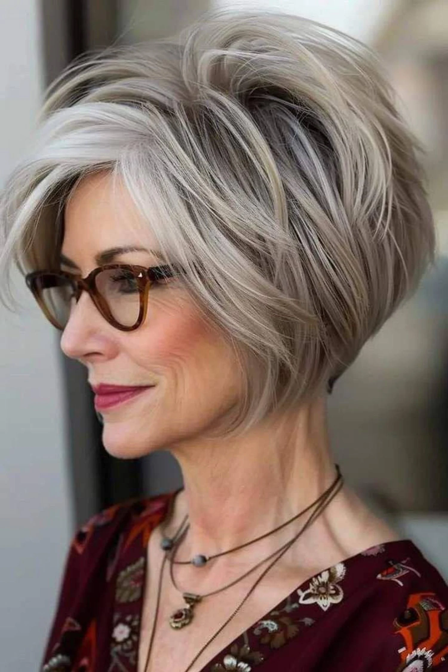 Voluminous Silver Pixie with Swept Fringe — Winter Haircuts for Women Over 60