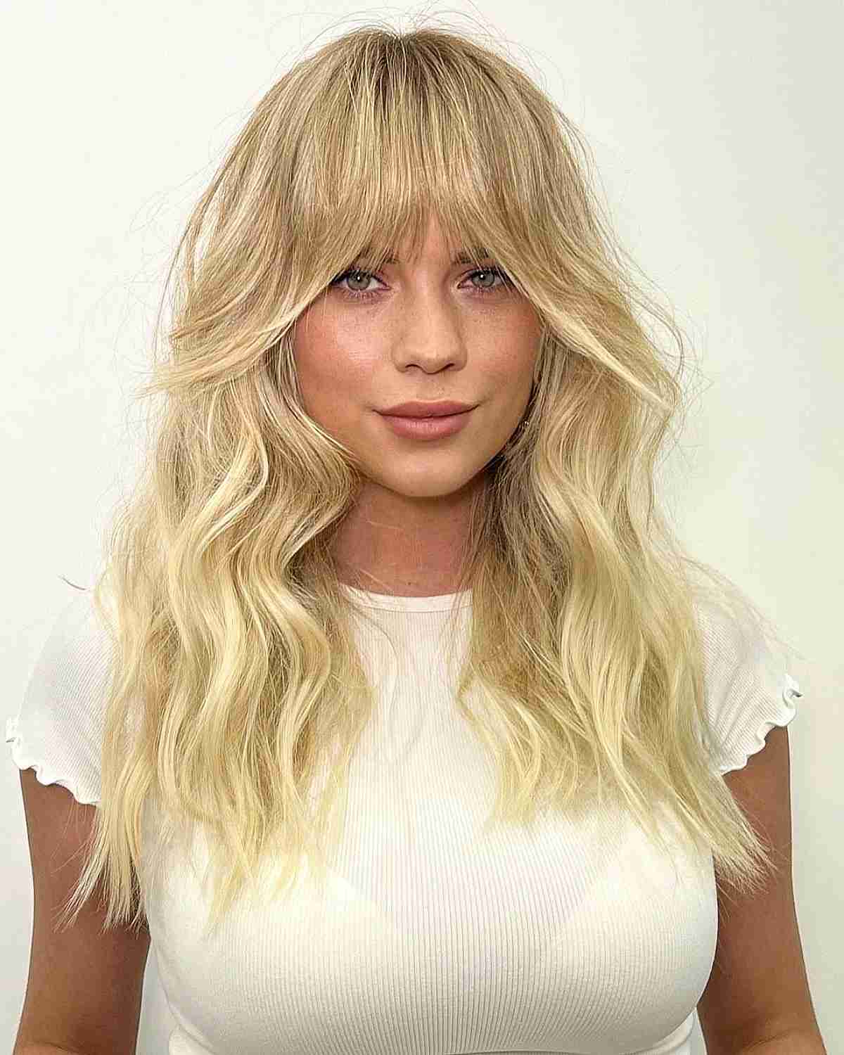 Ash Blonde Collarbone Waves with Full Bangs Ash Blonde Collarbone Waves with Full Bangs — Classy Blonde Wavy Hair