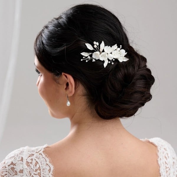 Thick Dark Brown Chignon With Floral Piece Thick Dark Brown Chignon With Floral Piece — Classy Bridesmaid Hair Updo