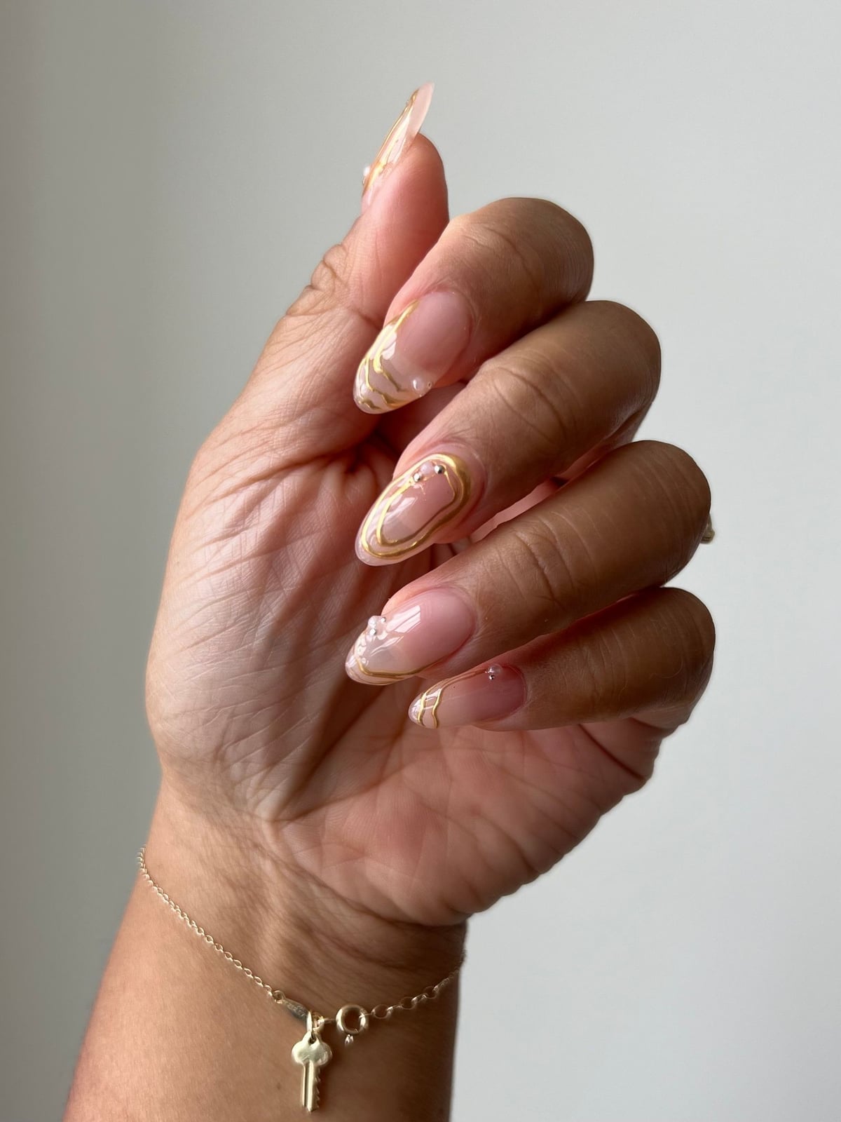 Long Oval Nude With Abstract Gold Line Art — Classy Bridesmaid Nails