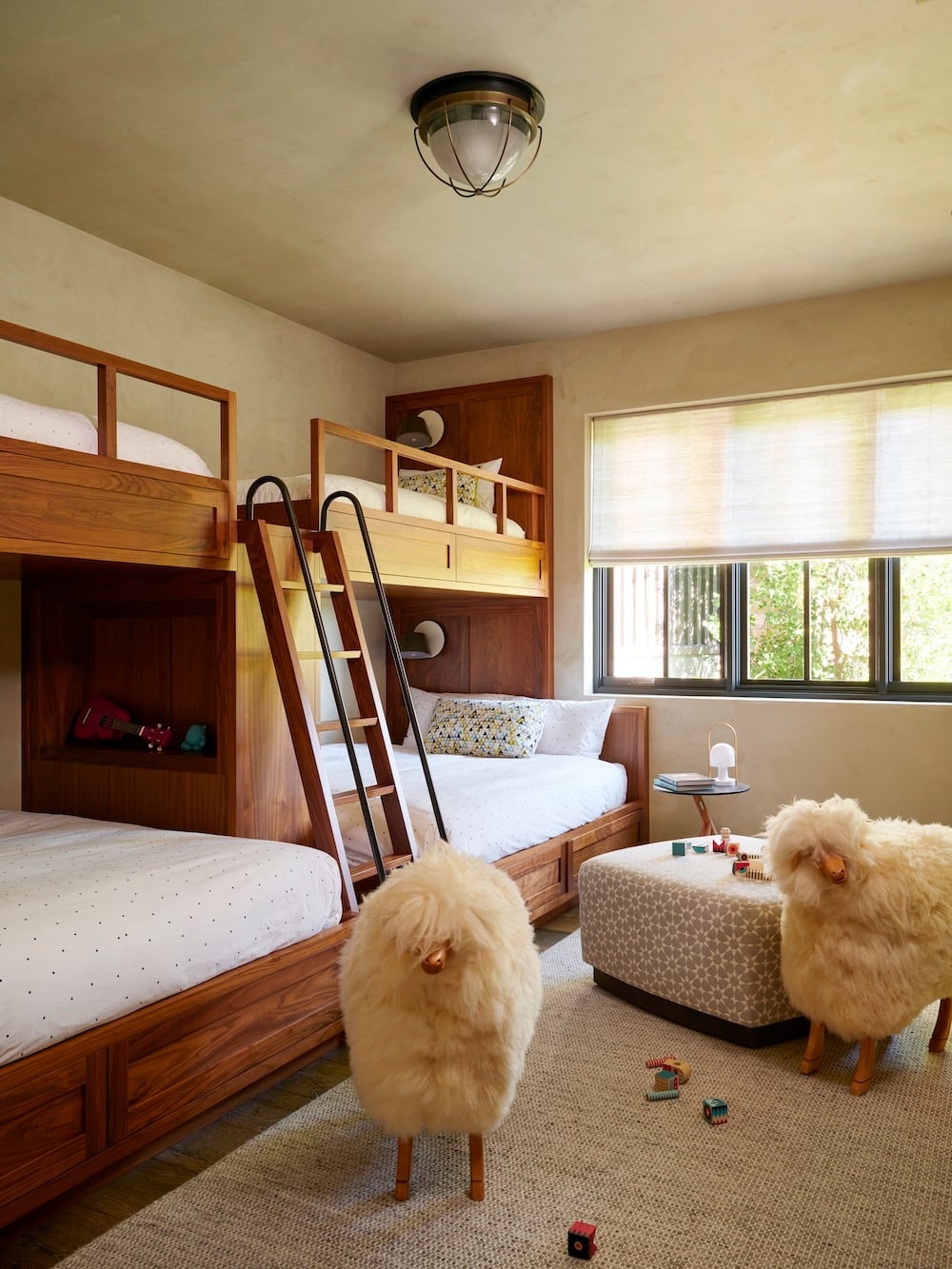 Dark Wood Built In Bunk Bed with Sheepskin Stools — Classy Bunk Bed Ideas