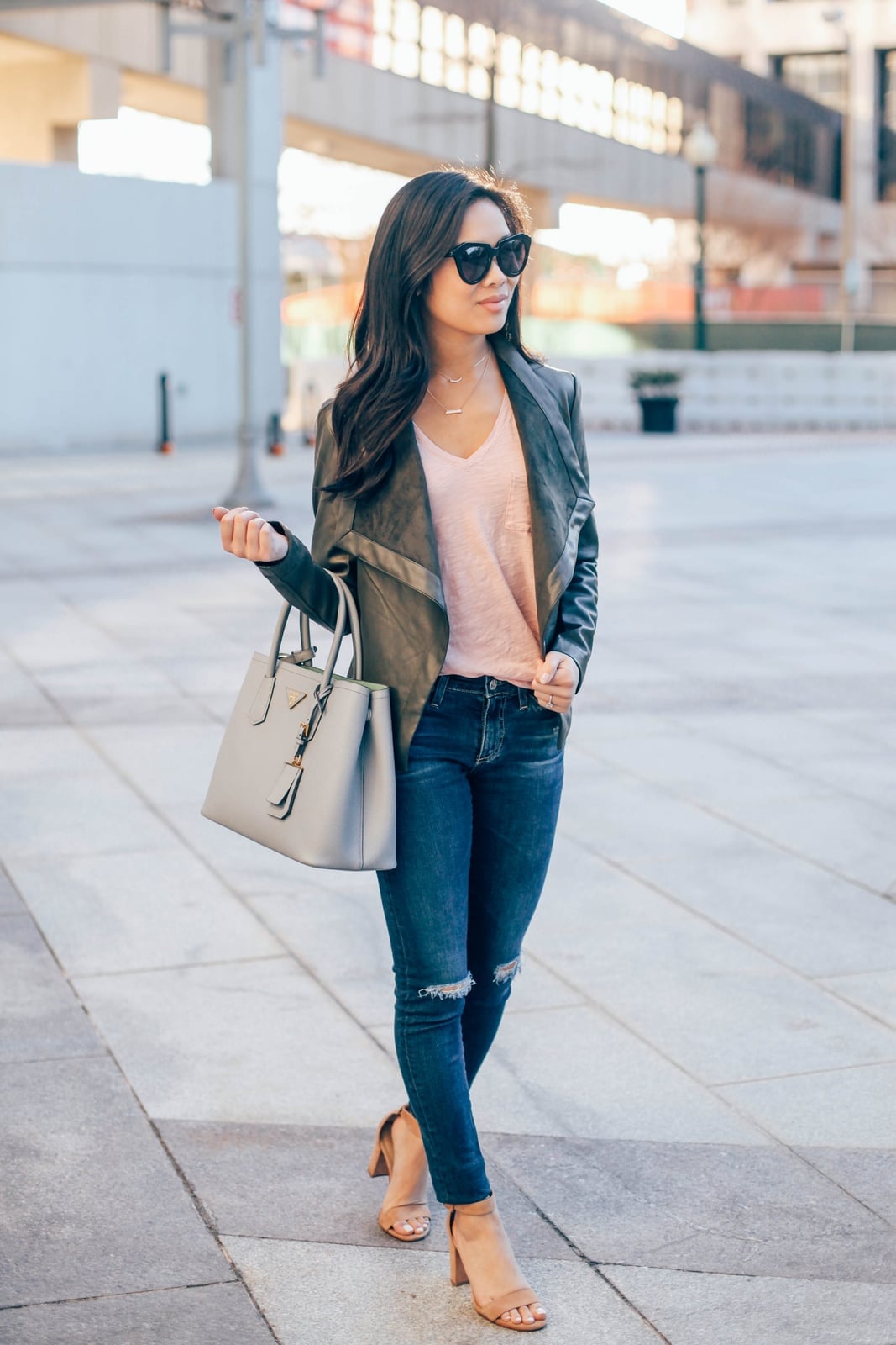 Dark moto jacket with pink top and skinny jeans — Classy Jacket Outfits