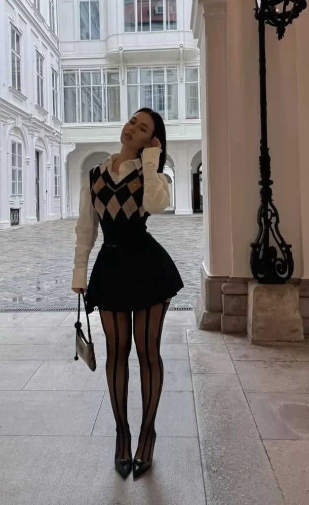 Argyle knit vest over white shirt with black pleated mini skirt — Classy Office Siren Outfits