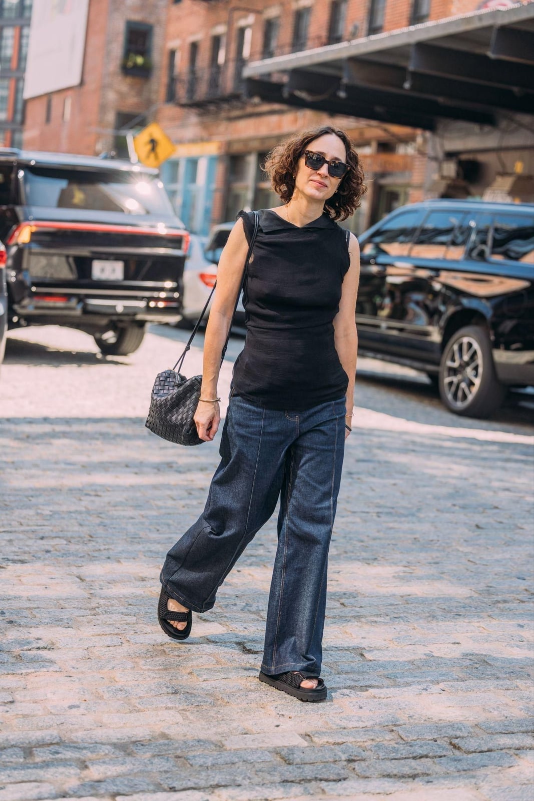 Black sleeveless top with dark wash wide-leg jeans — Classy Streetwear Outfits