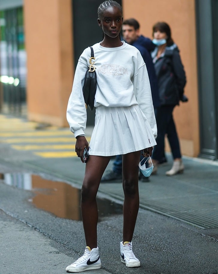 Graphic Sweatshirt Over White Pleated Mini Skirt Graphic Sweatshirt Over White Pleated Mini Skirt — Classy Tennis Skirt Outfits
