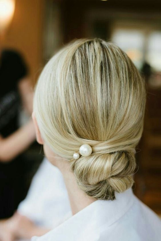 Sleek Platinum Blonde Low Bun With Pearl Accessory — Classy Wedding Hair
