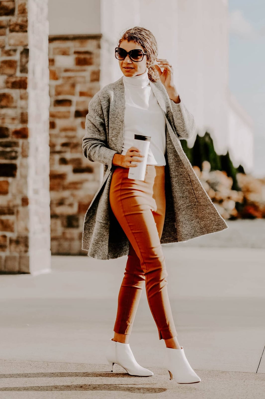 Rust orange slim trousers with white turtleneck and cardigan — Classy Work Outfits