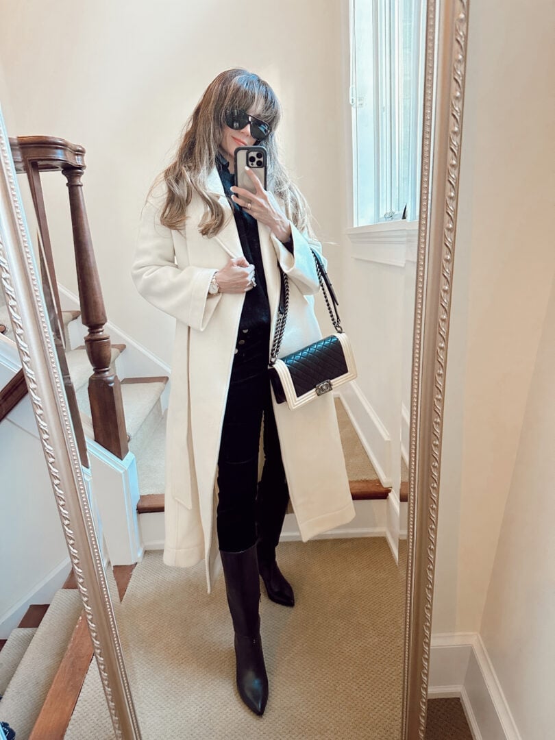 Long white wool coat over black turtleneck and velvet trousers — Classy Work Outfits
