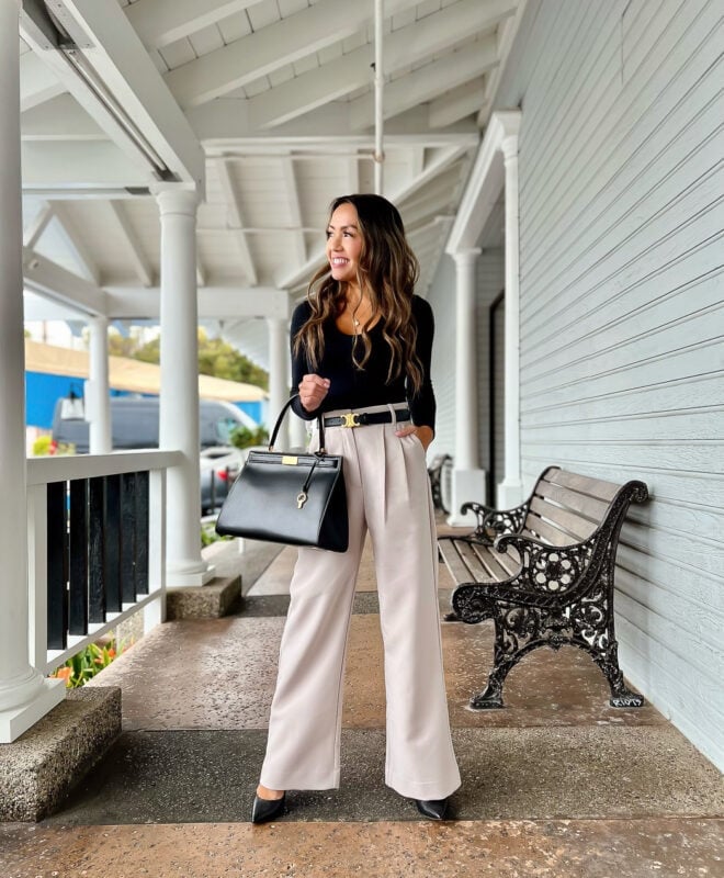 Black top with beige wide-leg trousers and gold buckle belt — Classy Work Outfits